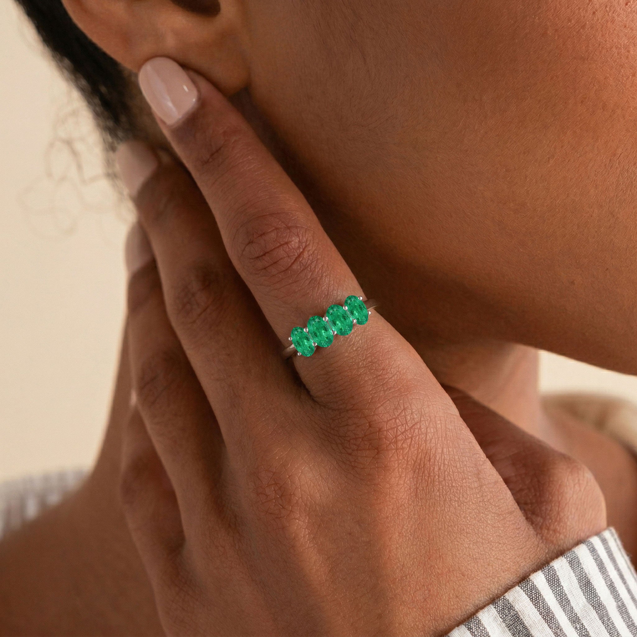oval emerald jewelry, four stone stacking ring, emerald birthday gift, gemstone fashion accessory, fine craftsmanship, graceful ring, luxury gift for women, delicate gemstone band, modern elegance, green gemstone accessory, stylish jewelry, artisan ring