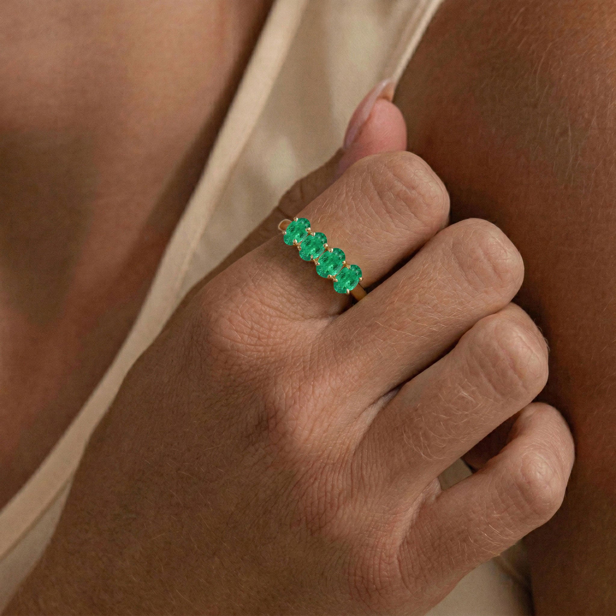 emerald jewelry gift, classic four stone band, vibrant green gemstones, oval gemstone ring, stackable fashion jewelry, timeless bridal ring, minimalist luxury, elegant gemstone accessory, women's fine jewelry, handcrafted elegance, anniversary present, birthday jewelry
