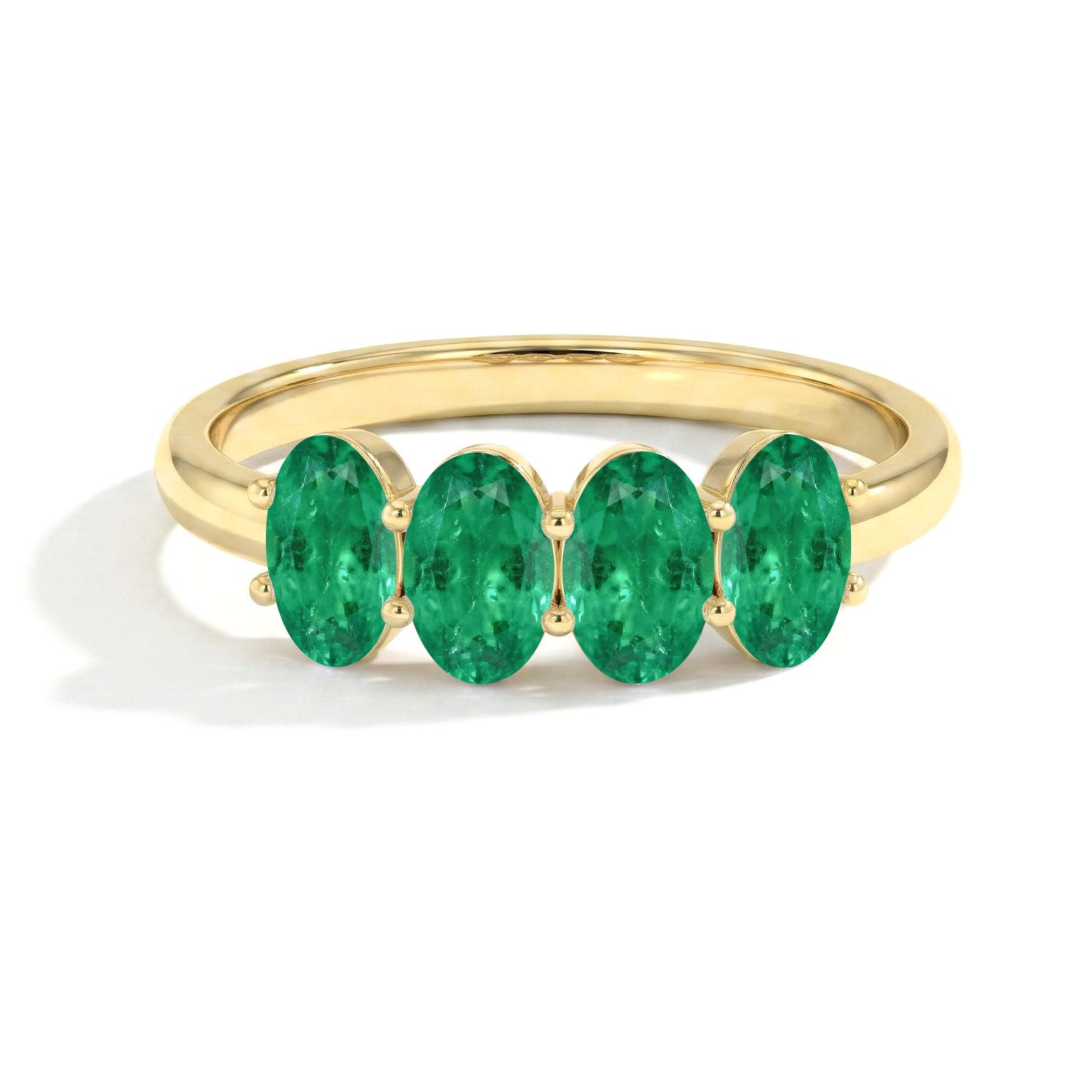 emerald jewelry collection, four oval emerald gemstones, elegant handcrafted ring, stackable band jewelry, luxury green gemstone accessory, bridal style ring, anniversary fashion jewelry, polished elegant finish, refined statement accessory, women's designer ring, timeless elegance, gift inspiration
