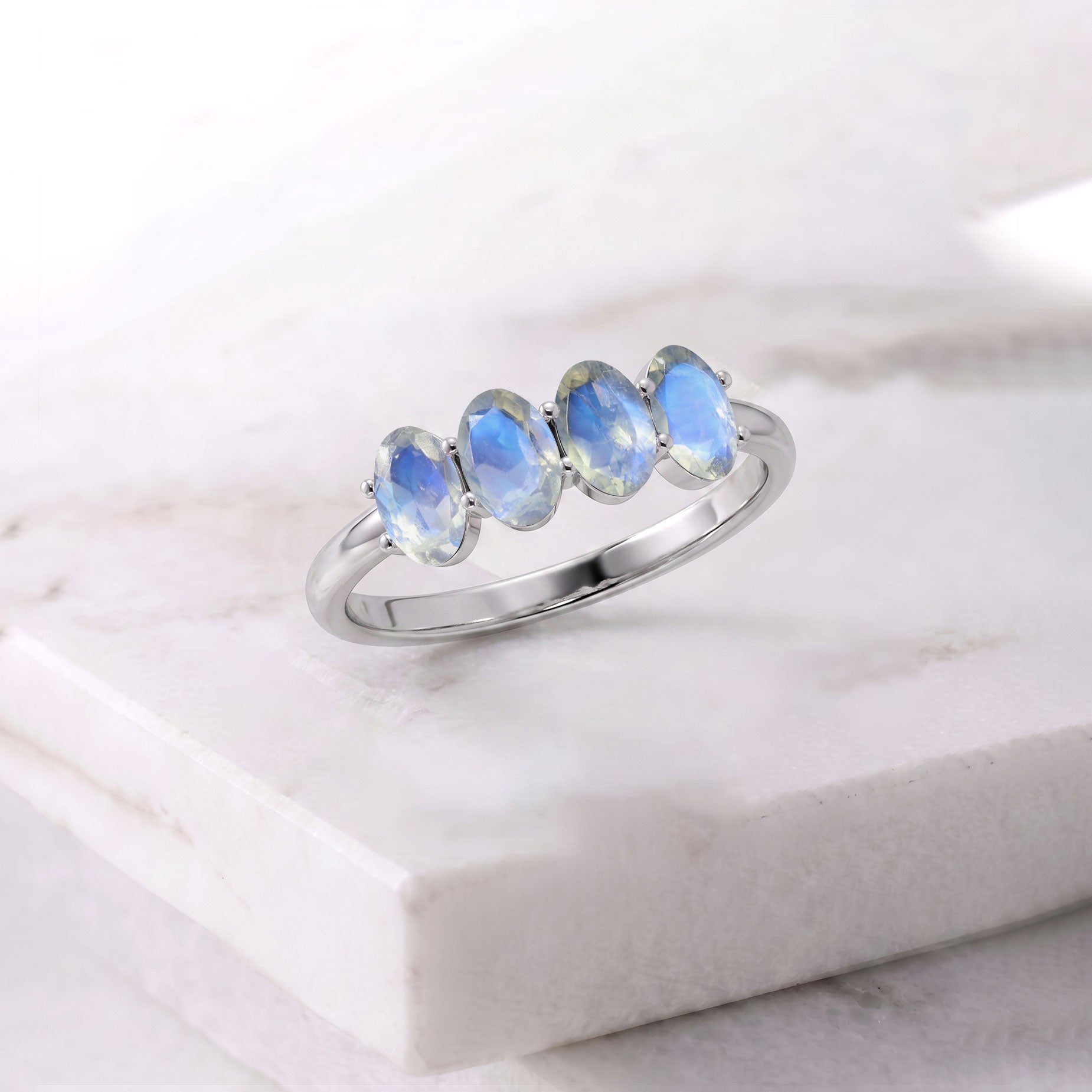 Moonstone Ring resting on luxurious white silk fabric, genuine natural moonstones with glowing blue reflections, handcrafted Yellow Gold Filled jewelry, polished elegant band, premium artisan craftsmanship, June birthstone ring, luxury gift for wife, anniversary jewelry, birthday present, sophisticated fine gemstone jewelry with timeless elegance