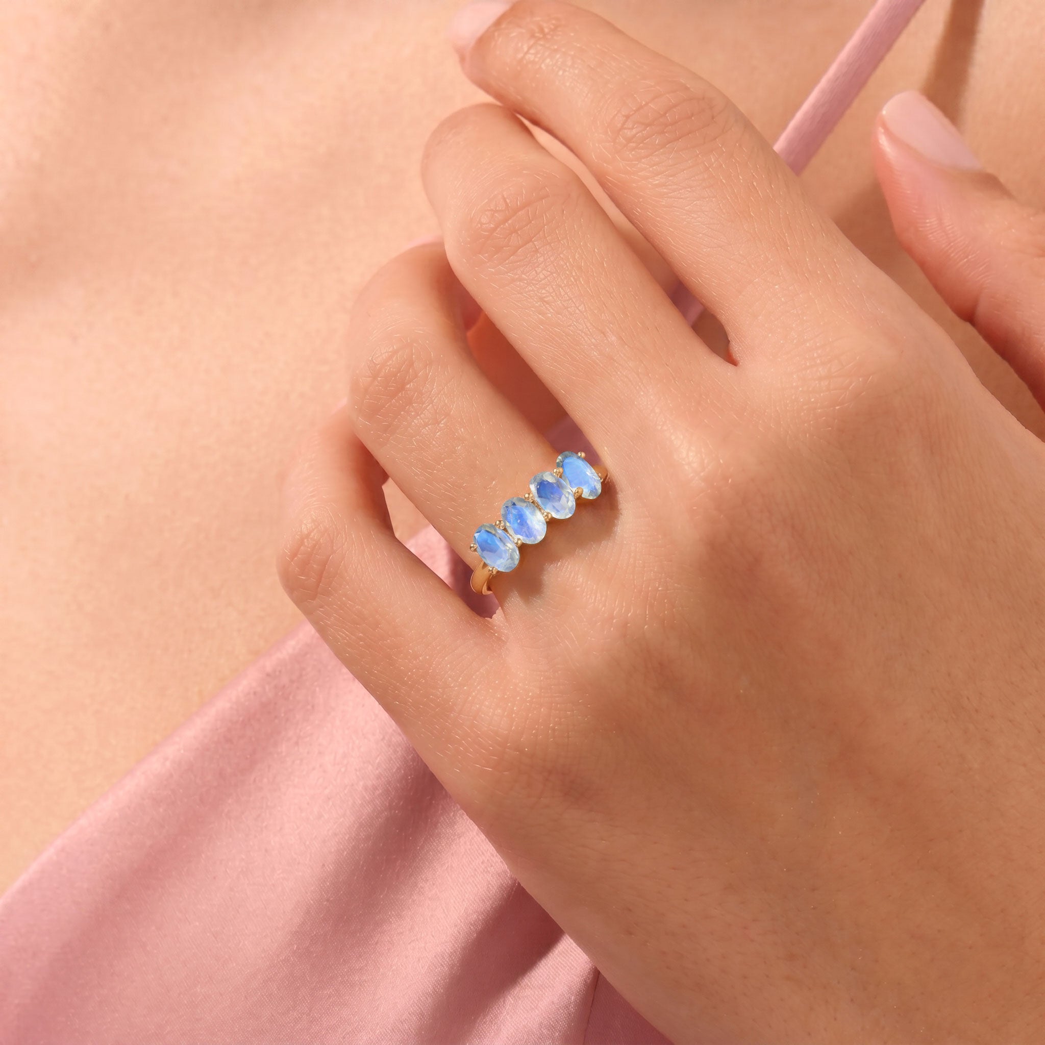 Premium studio close-up of Genuine Moonstone Ring, four oval moonstones with captivating natural blue adularescence, handcrafted 925 Sterling Silver ring, polished finish, elegant prong setting, luxury artisan jewelry, stackable moonstone ring, June birthstone accessory, timeless fine jewelry, handcrafted gemstone ring for women