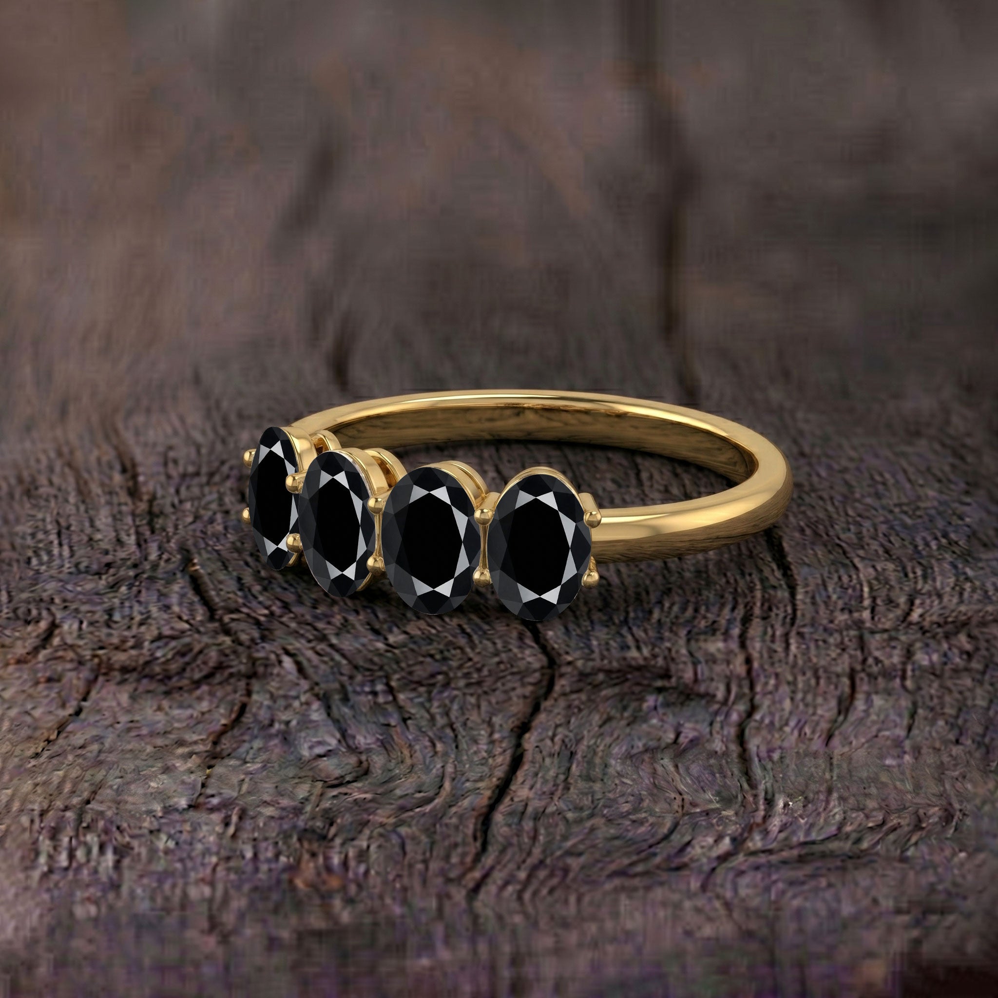 four oval black gemstones, elegant black ring, handcrafted gemstone jewelry, minimalist fashion ring, statement accessory, polished onyx ring, timeless design, stacking ring, everyday elegance, luxury jewelry