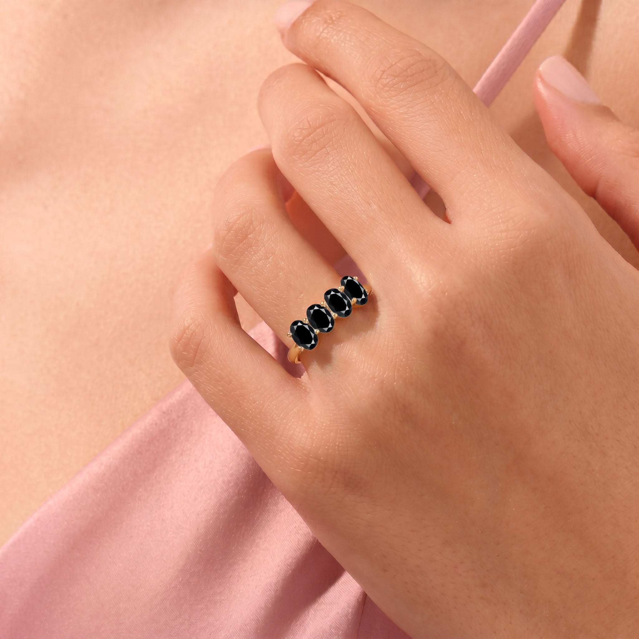 black onyx fashion ring, gemstone jewelry, oval cut black stones, artisan ring design, delicate band ring, contemporary jewelry, stackable gemstone ring, classic accessory, women's jewelry, elegant style