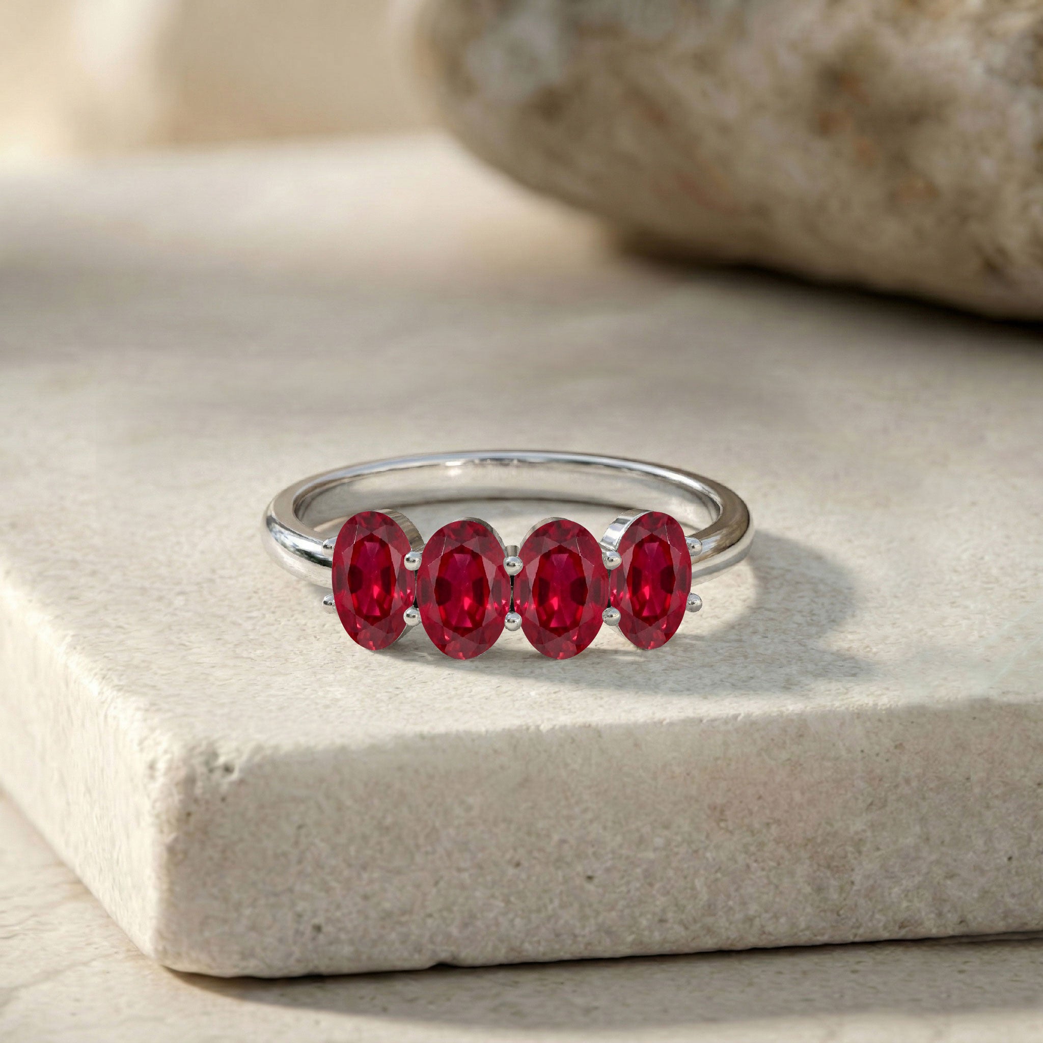 luxury ruby jewelry, elegant four stone ring, premium gemstone band, genuine red ruby, oval gemstone arrangement, sophisticated ring style, fine handcrafted jewelry, modern stacking ring, July birthstone jewelry, feminine accessory