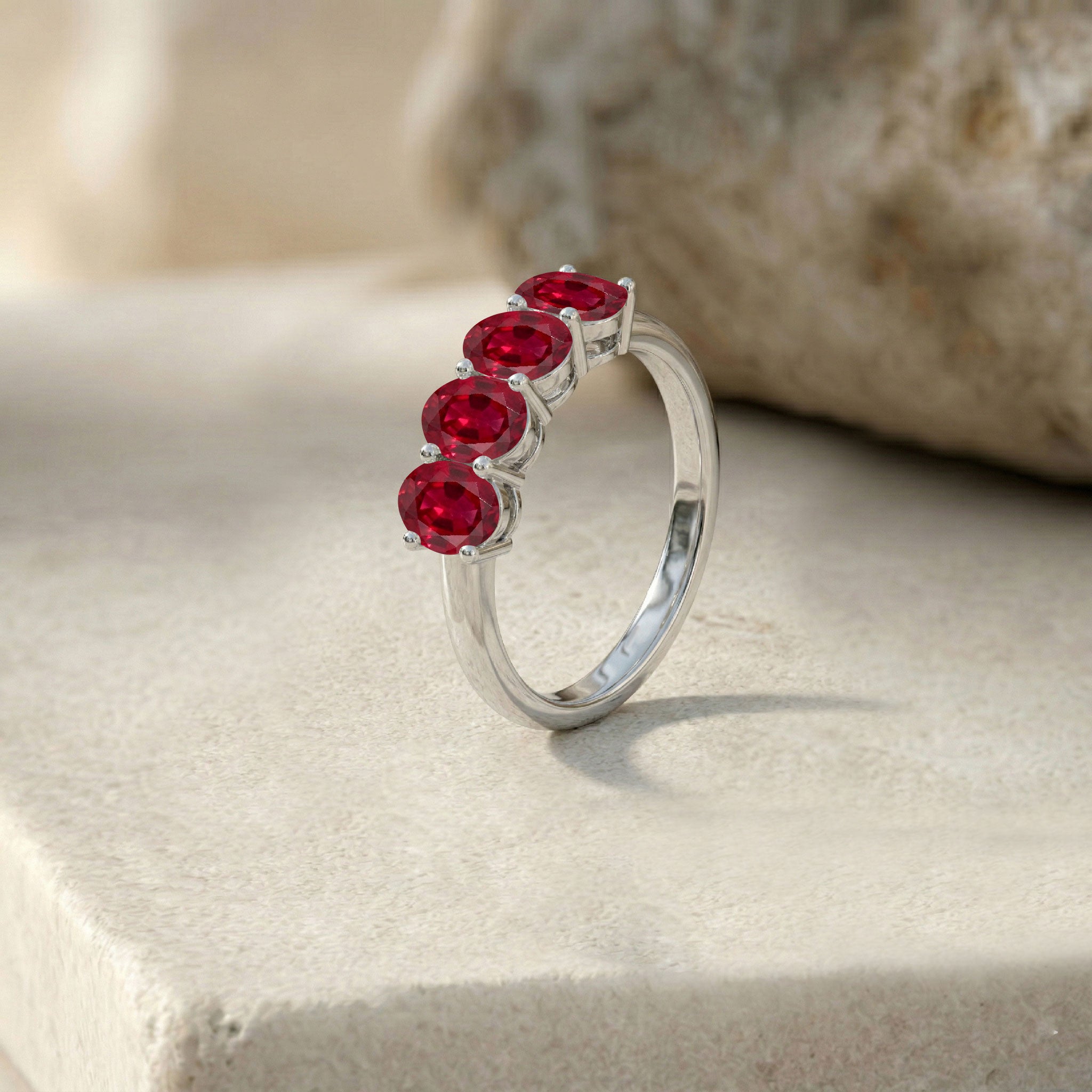 sparkling ruby ring, natural gemstone jewelry, oval faceted ruby stones, contemporary fine ring, sleek gemstone design, everyday luxury accessory, elegant red gemstone jewelry, premium craftsmanship, stylish women's band, classic beauty
