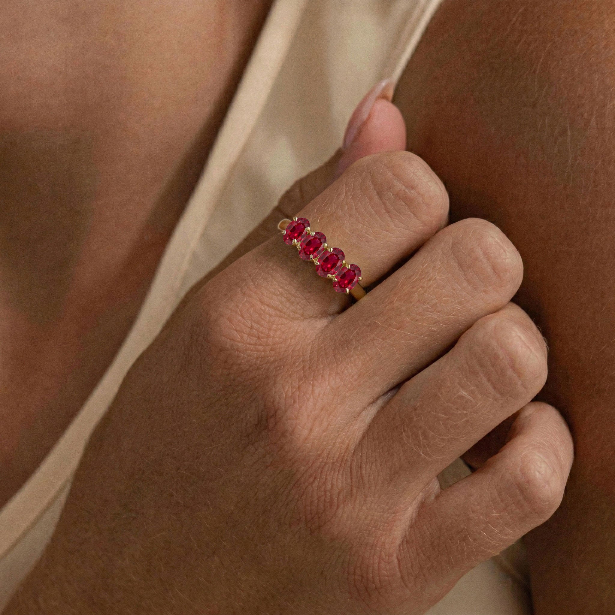 genuine ruby birthstone ring, four oval gemstones, elegant polished band, sophisticated jewelry style, luxury stacking ring, artisan ruby craftsmanship, timeless anniversary ring, premium gemstone accessory, vibrant ruby sparkle, fine jewelry