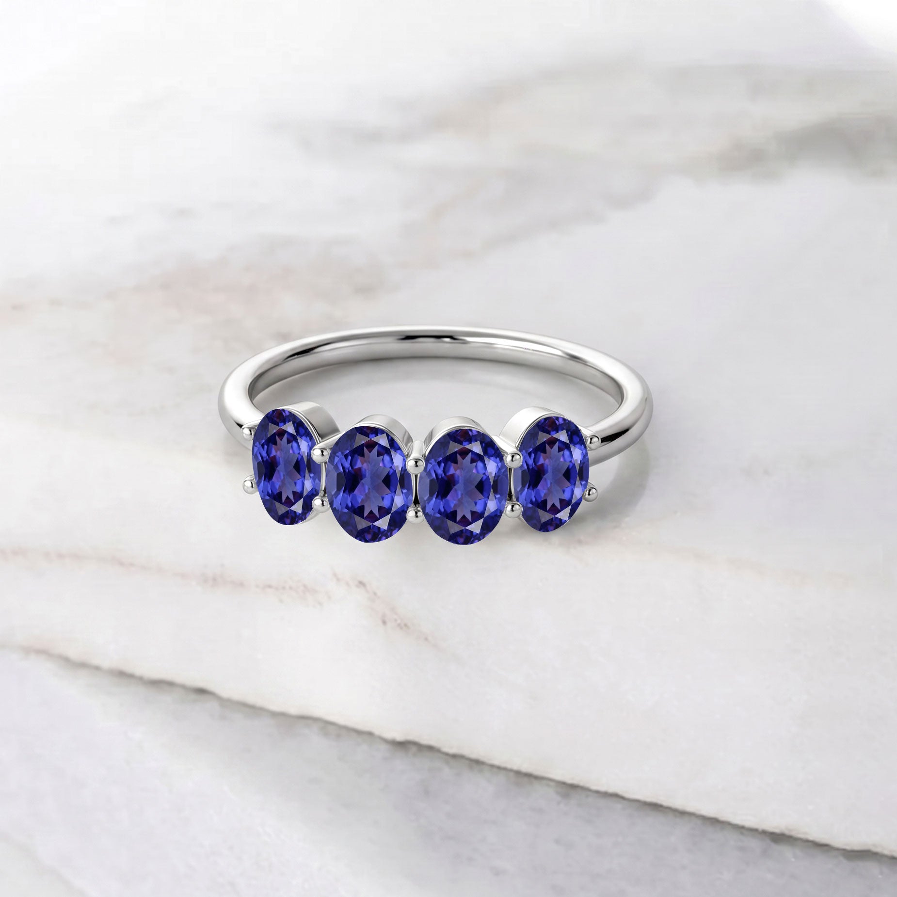 4 stone oval tanzanite ring, premium gold jewelry, boutique gemstone band, exclusive artisan jewelry, luxury fashion accessory, elegant women's ring, fine gemstone jewelry, signature designer ring, handcrafted luxury, sophisticated fashion ring