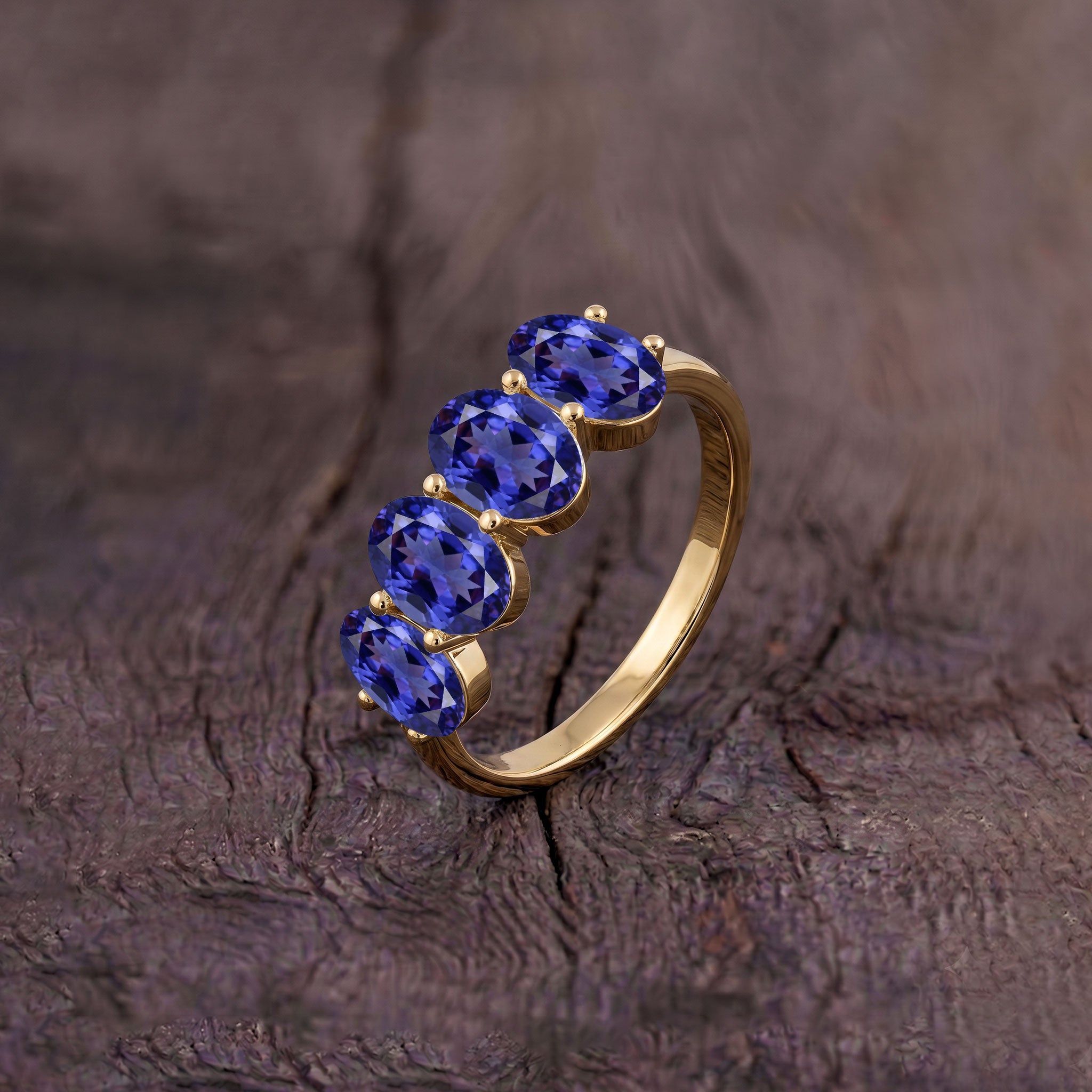 Four stone tanzanite designer ring, premium yellow gold jewelry, boutique gemstone ring, artisan gemstone jewelry, luxury fashion accessory, elegant women's gift ring, fine tanzanite jewelry, signature fashion ring, handcrafted luxury, high end gemstone ring
