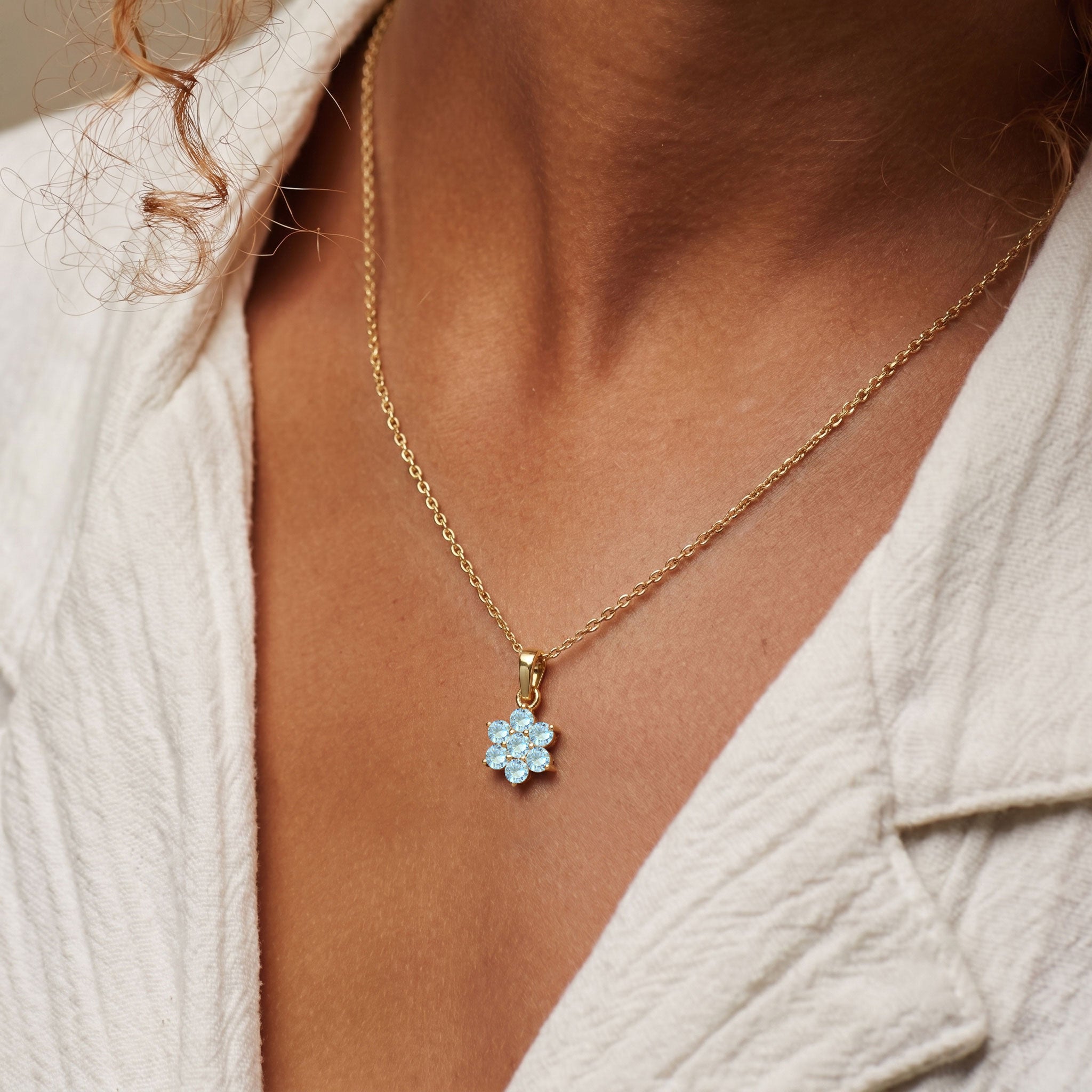 Genuine Aquamarine gemstone floral necklace with seven round stones in a delicate setting.