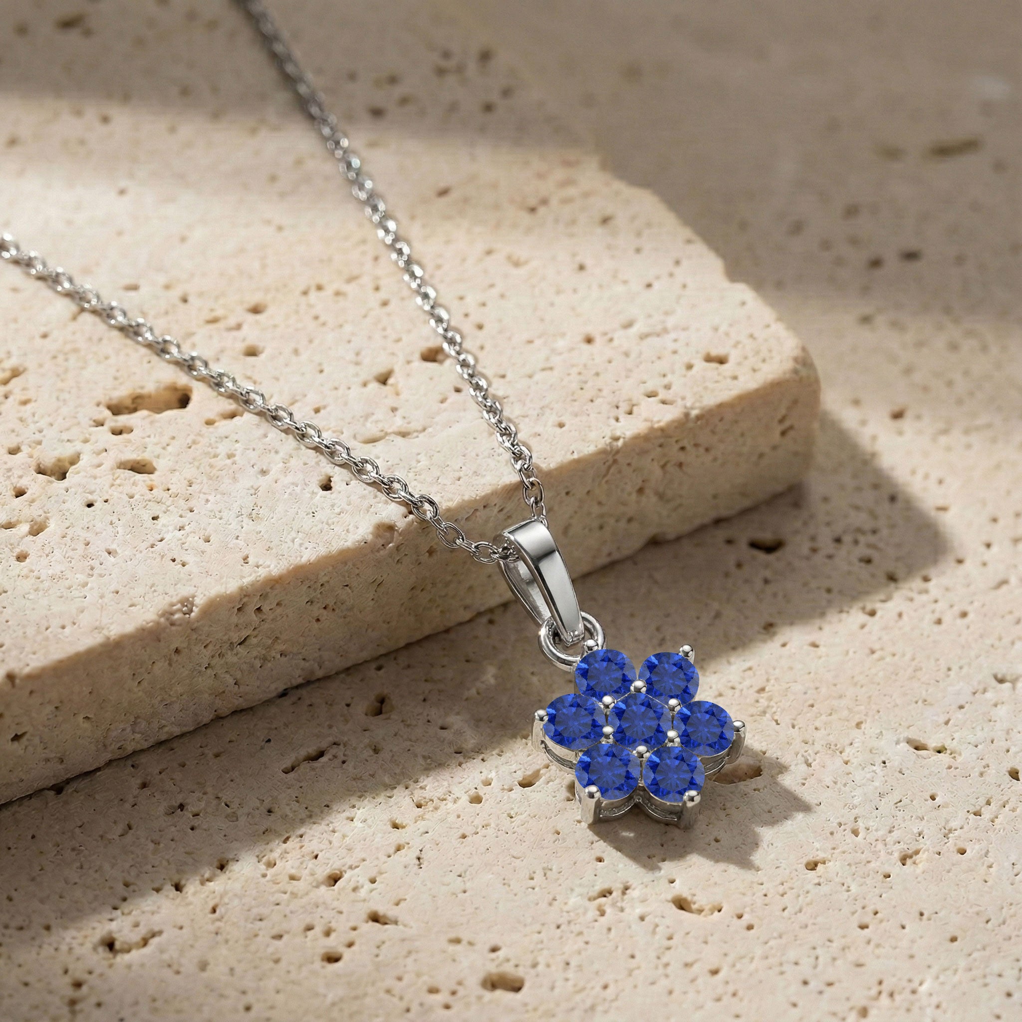 September birthstone Blue Sapphire flower pendant necklace for women with fine jewelry design.