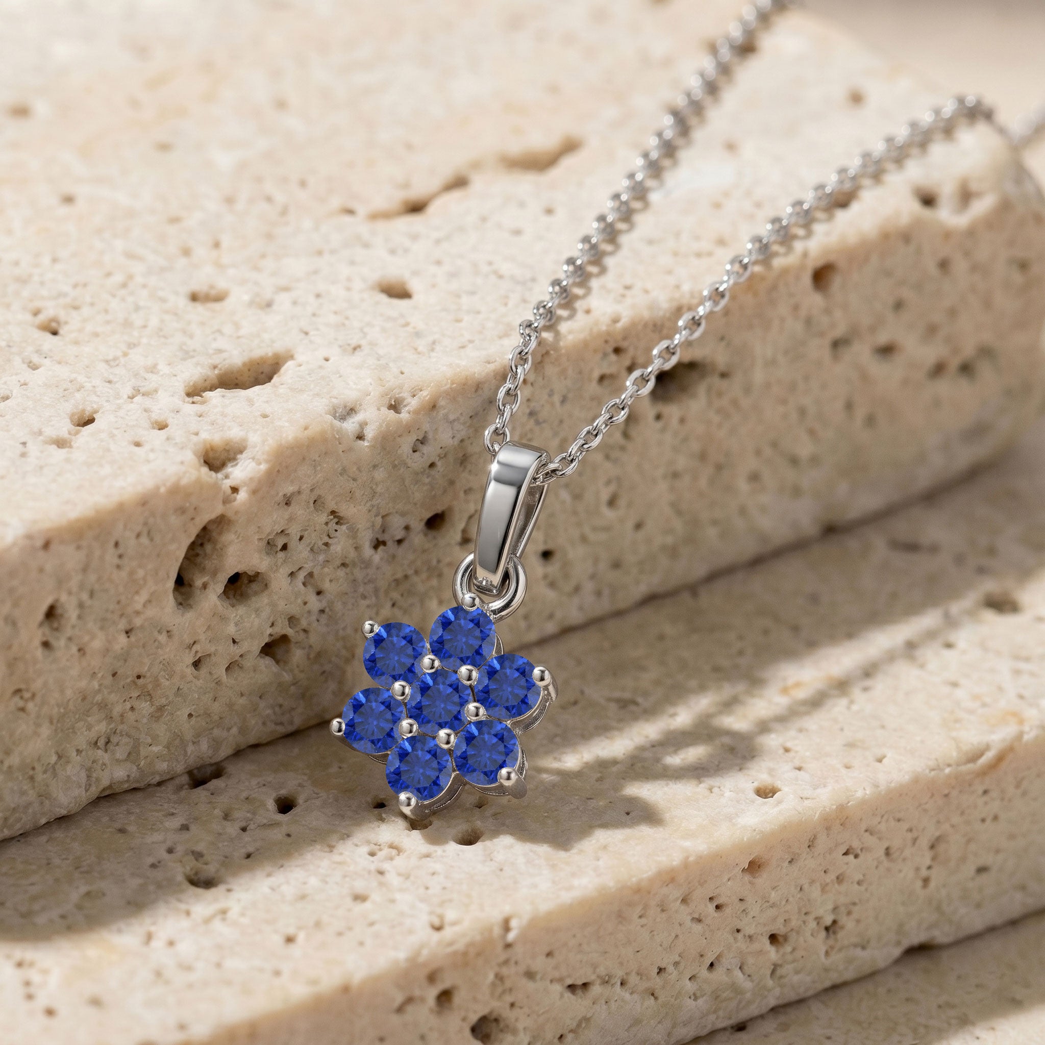Women's Blue Sapphire pendant necklace with adjustable chain and gemstone details.