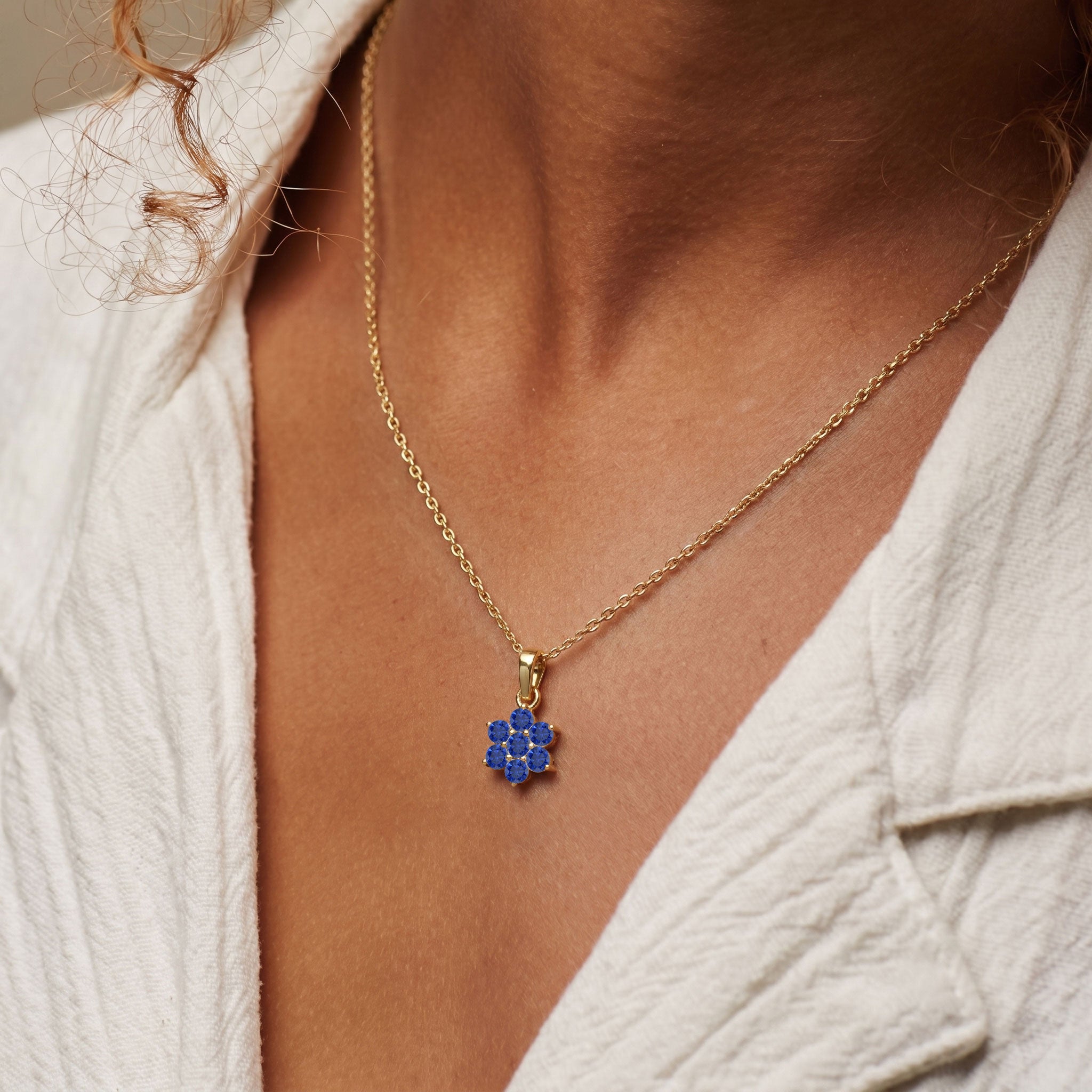 Handmade Blue Sapphire floral pendant necklace with seven 3MM round gemstones.