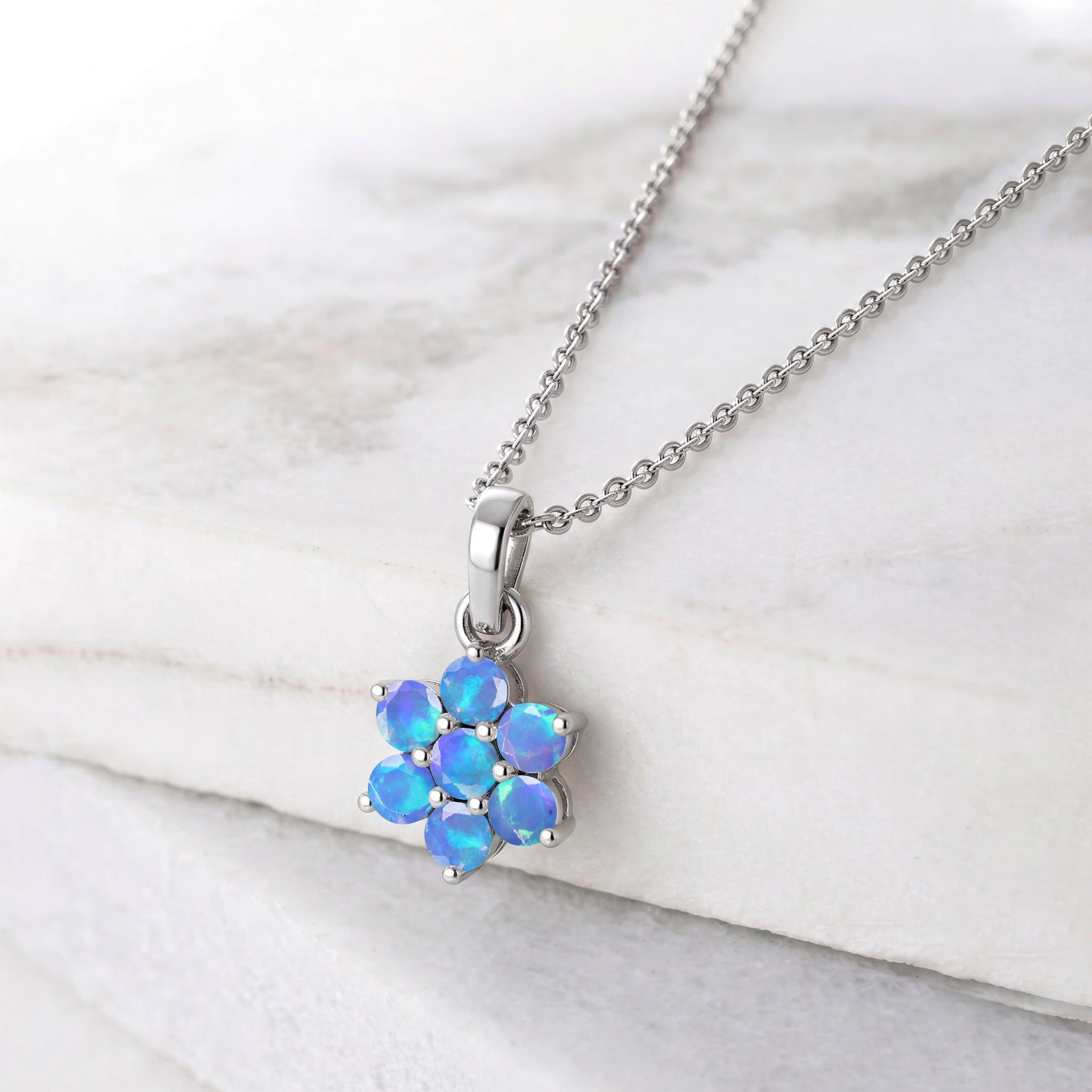 October birthstone Blue Opal necklace with a delicate flower pendant design.