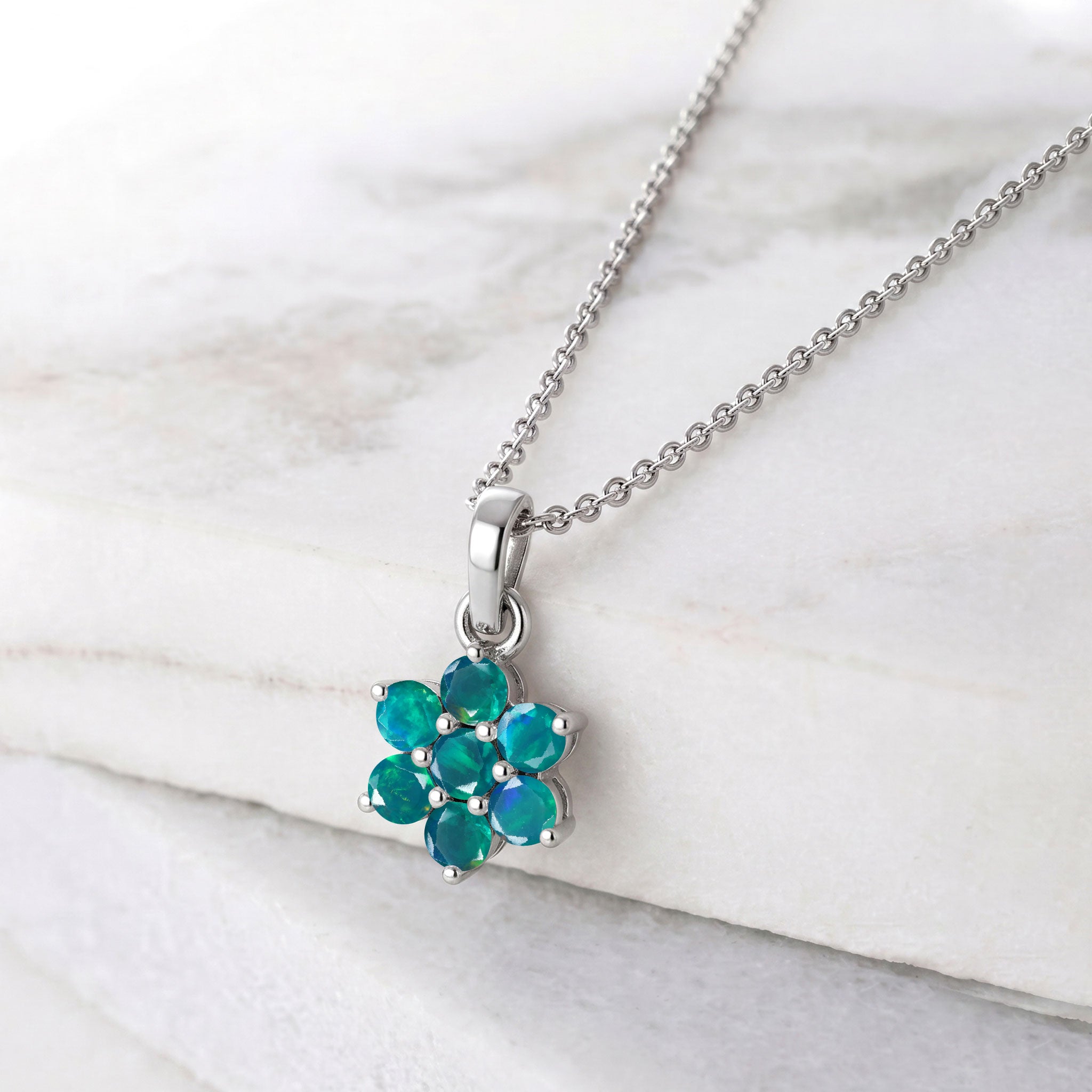 Floral gemstone necklace featuring seven round green opal stones