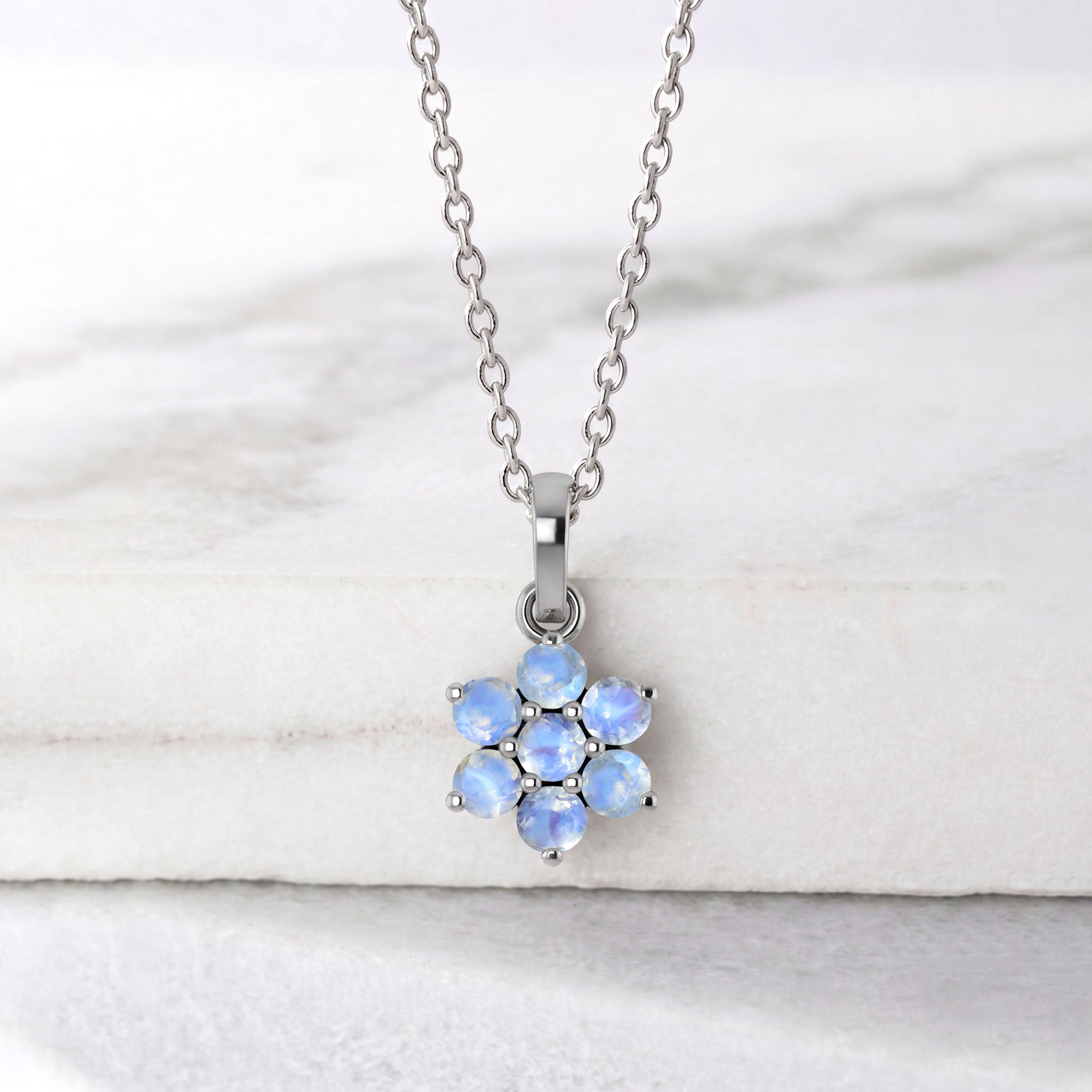 Dainty moonstone pendant necklace with delicate floral pendant design
