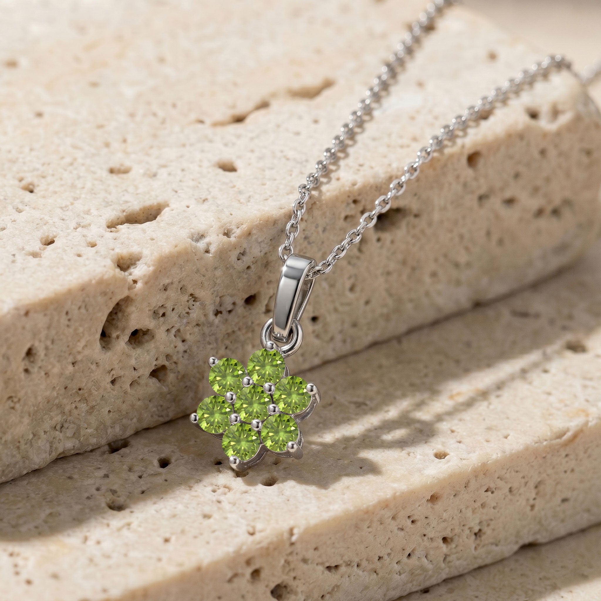 Floral gemstone necklace featuring seven round peridot stones