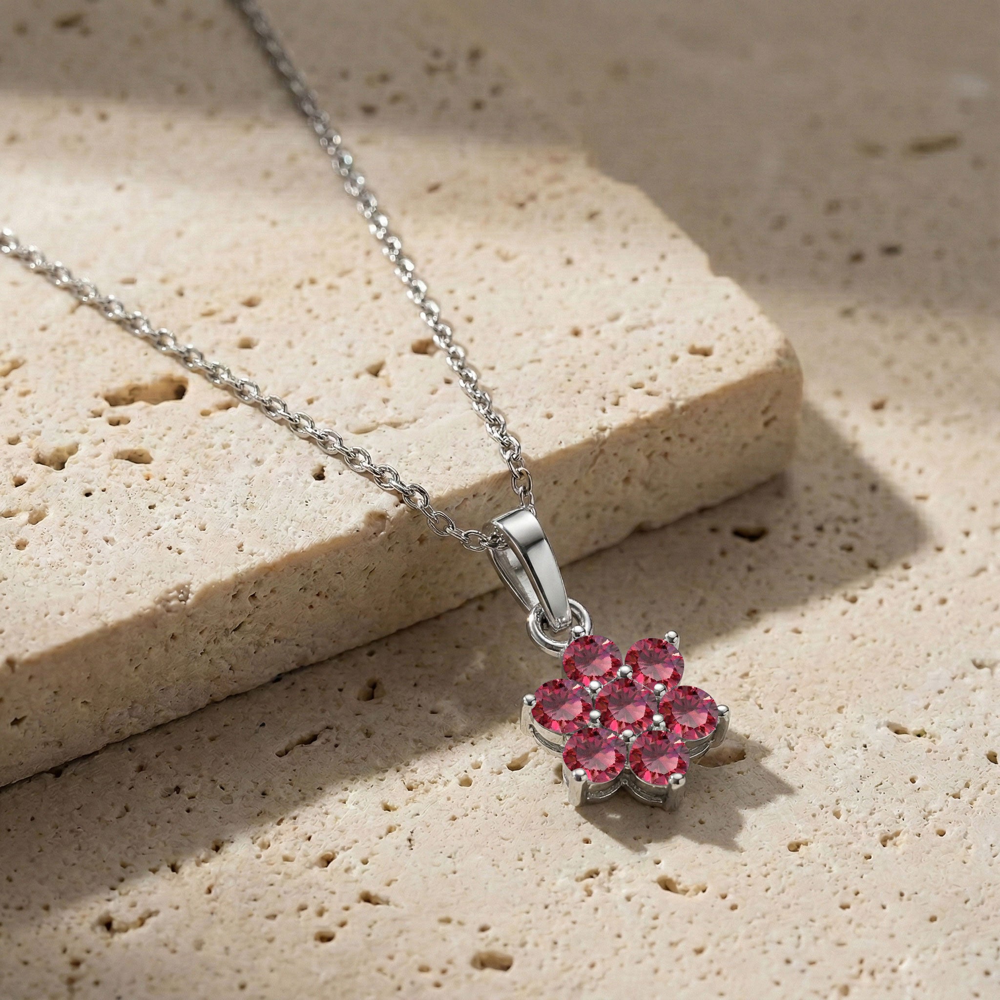 Dainty ruby pendant necklace with delicate floral pendant design