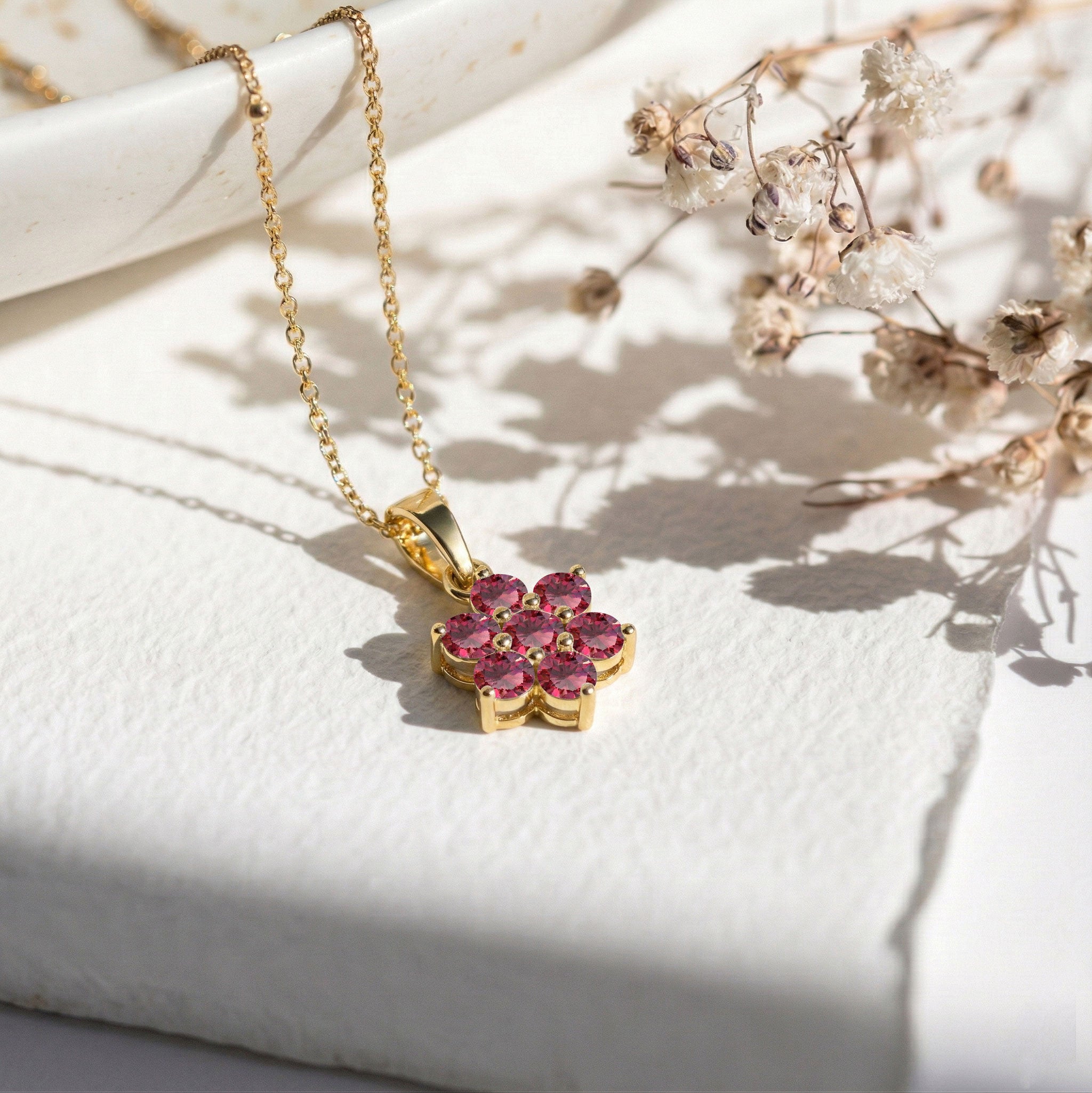 Minimalist floral pendant necklace with sparkling ruby gemstones
