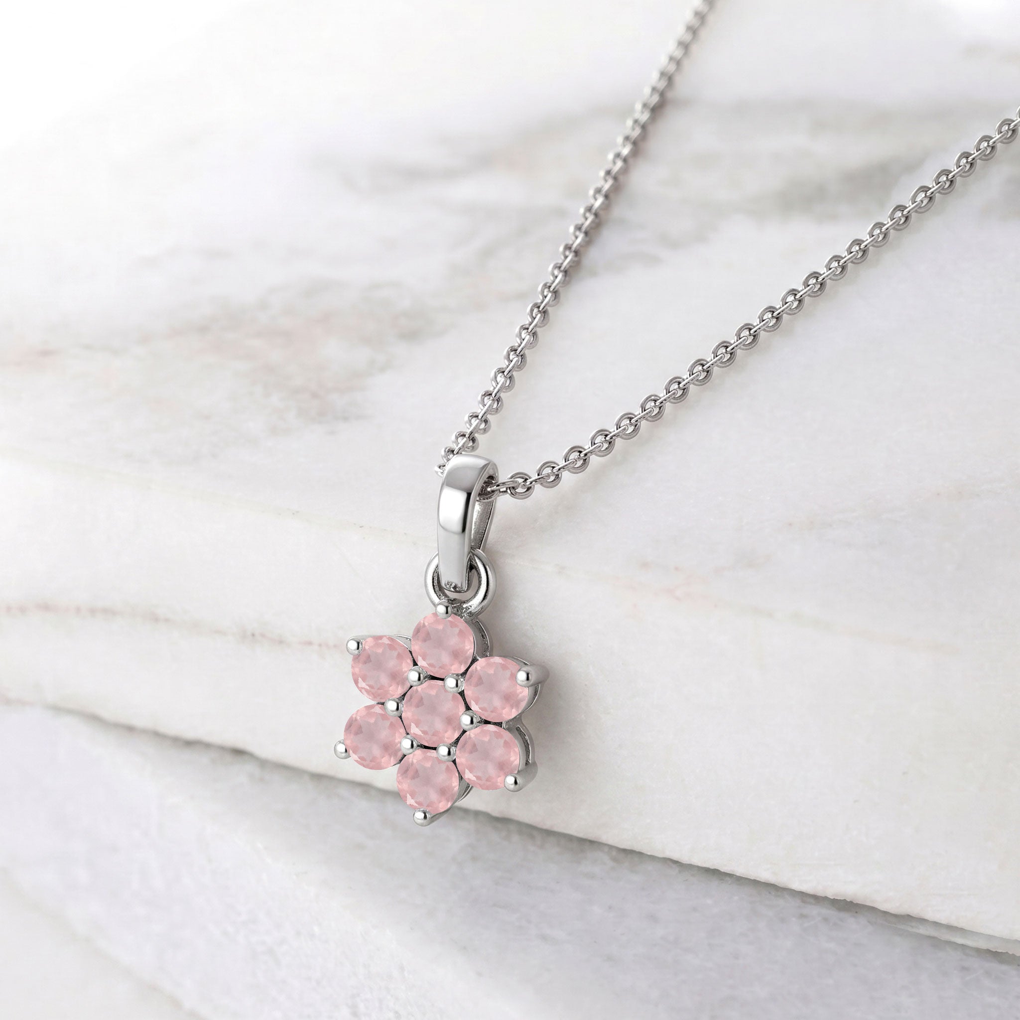 Floral gemstone necklace featuring seven round rose quartz stones