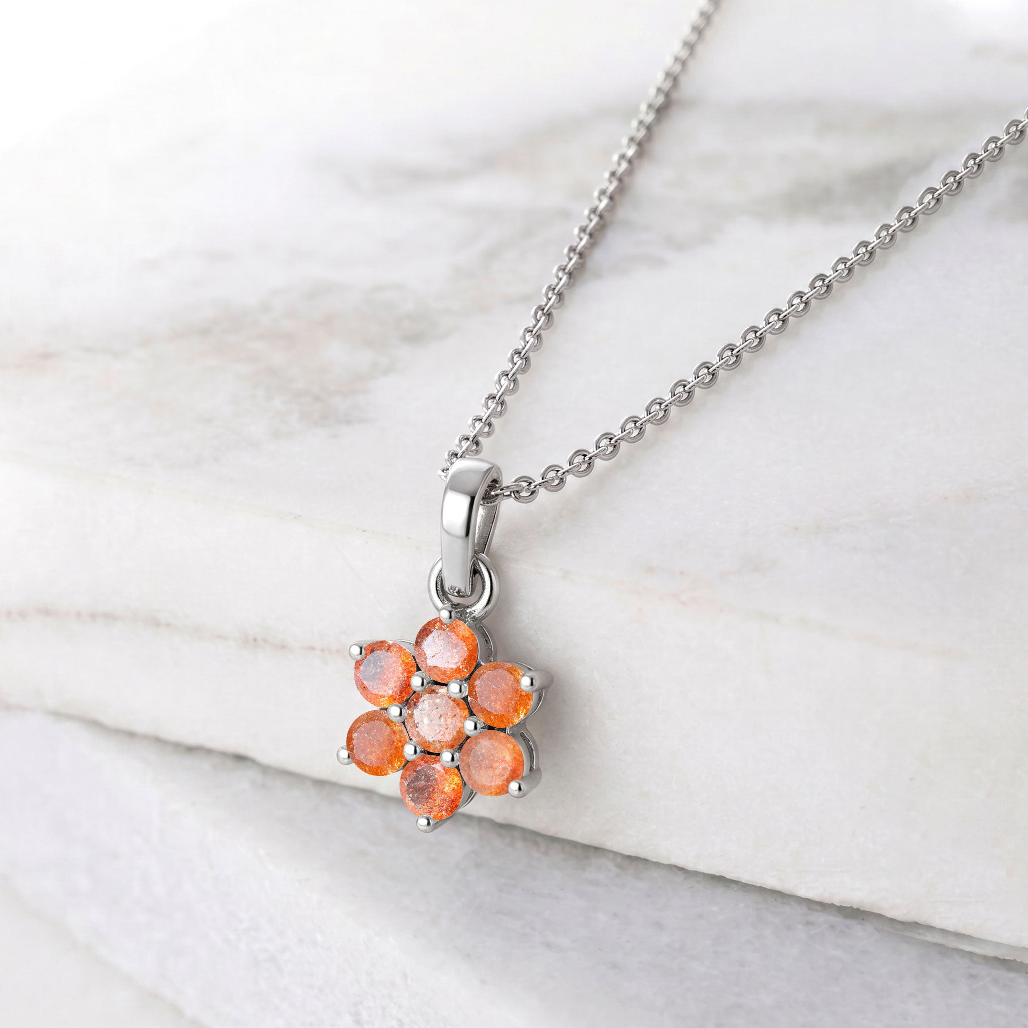 Round sunstone gemstones arranged in a graceful flower pendant necklace