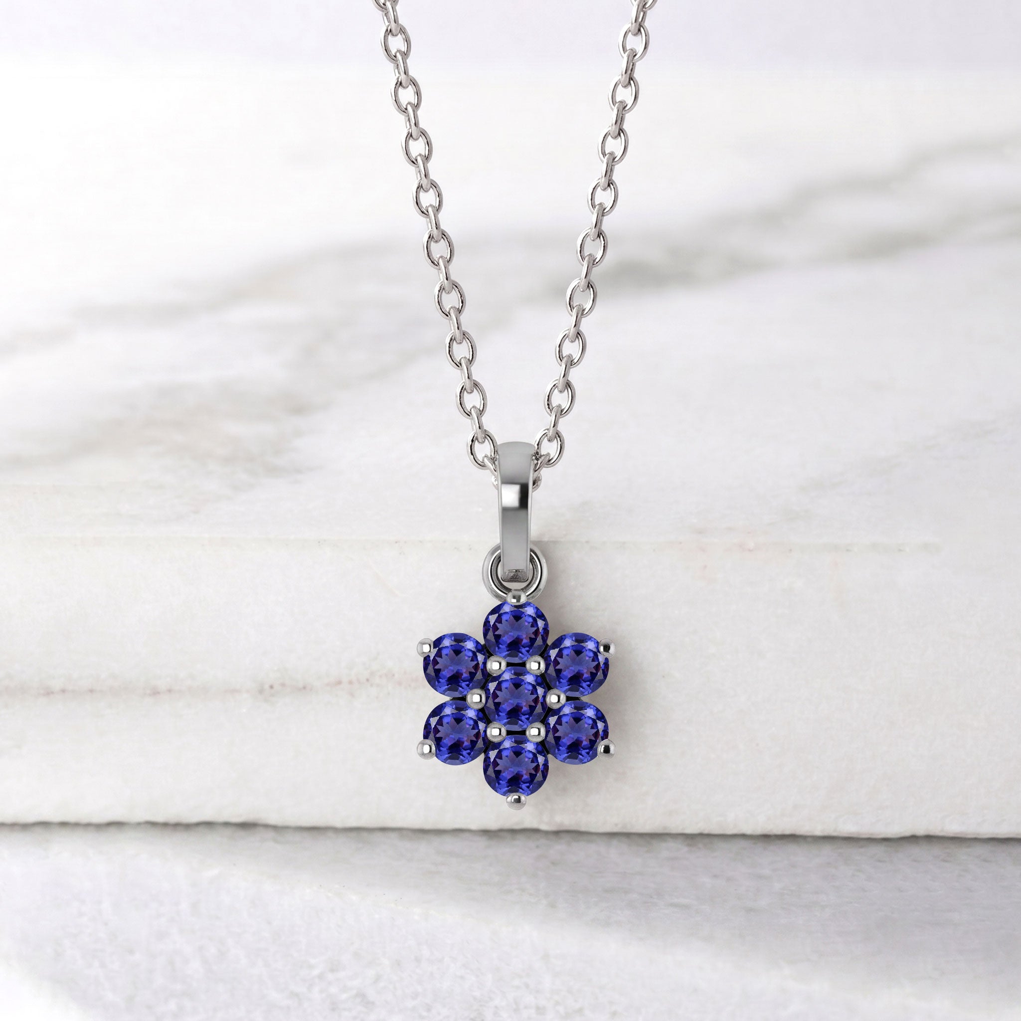 Dainty tanzanite pendant necklace with delicate flower inspired gemstone setting