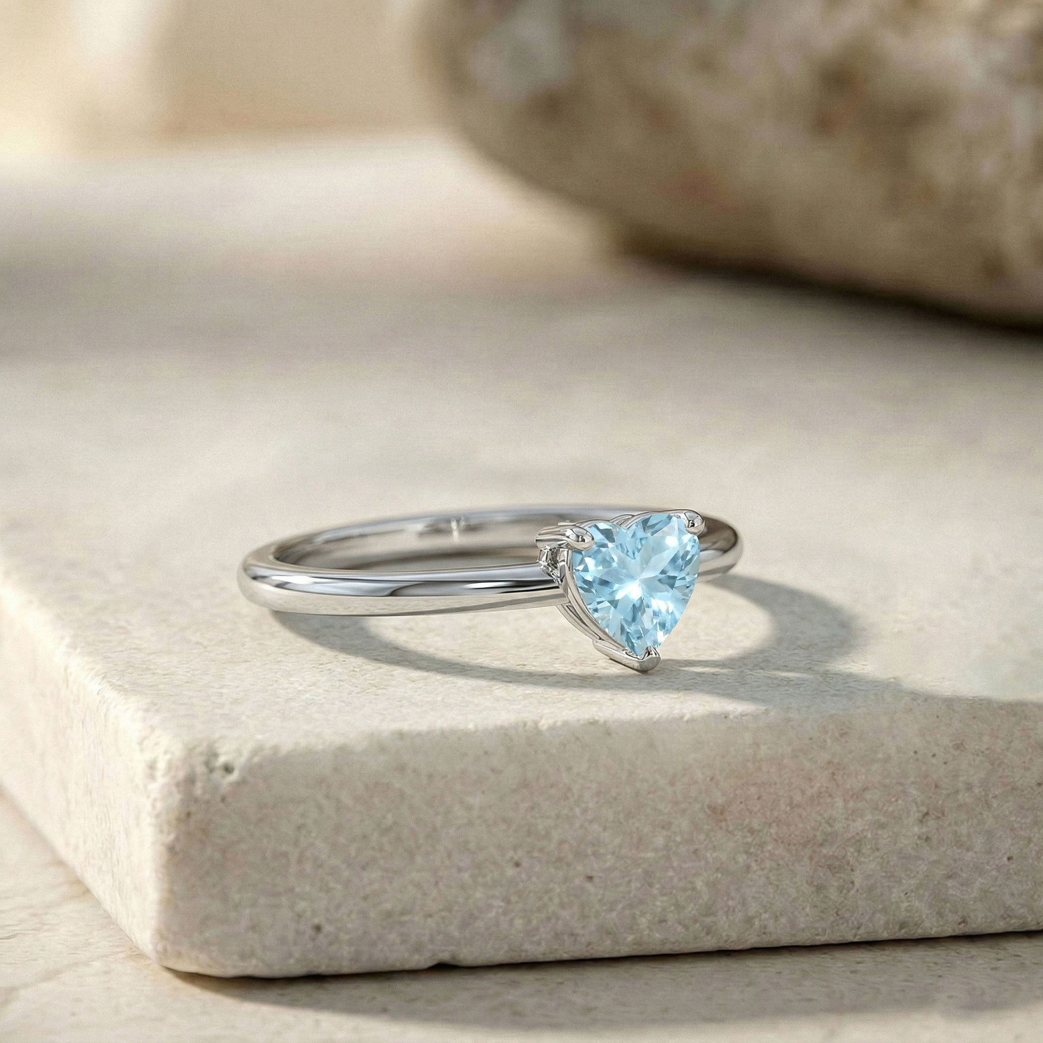 Aquamarine gemstone solitaire, heart engagement ring, blue birthstone jewelry, women's fashion ring, delicate heart ring, simple luxury jewelry, three claw setting, March jewelry gift, everyday elegance, fine gemstone accessory, romantic keepsake, bridal ring inspiration, gift for girlfriend, artisan jewelry, classic design