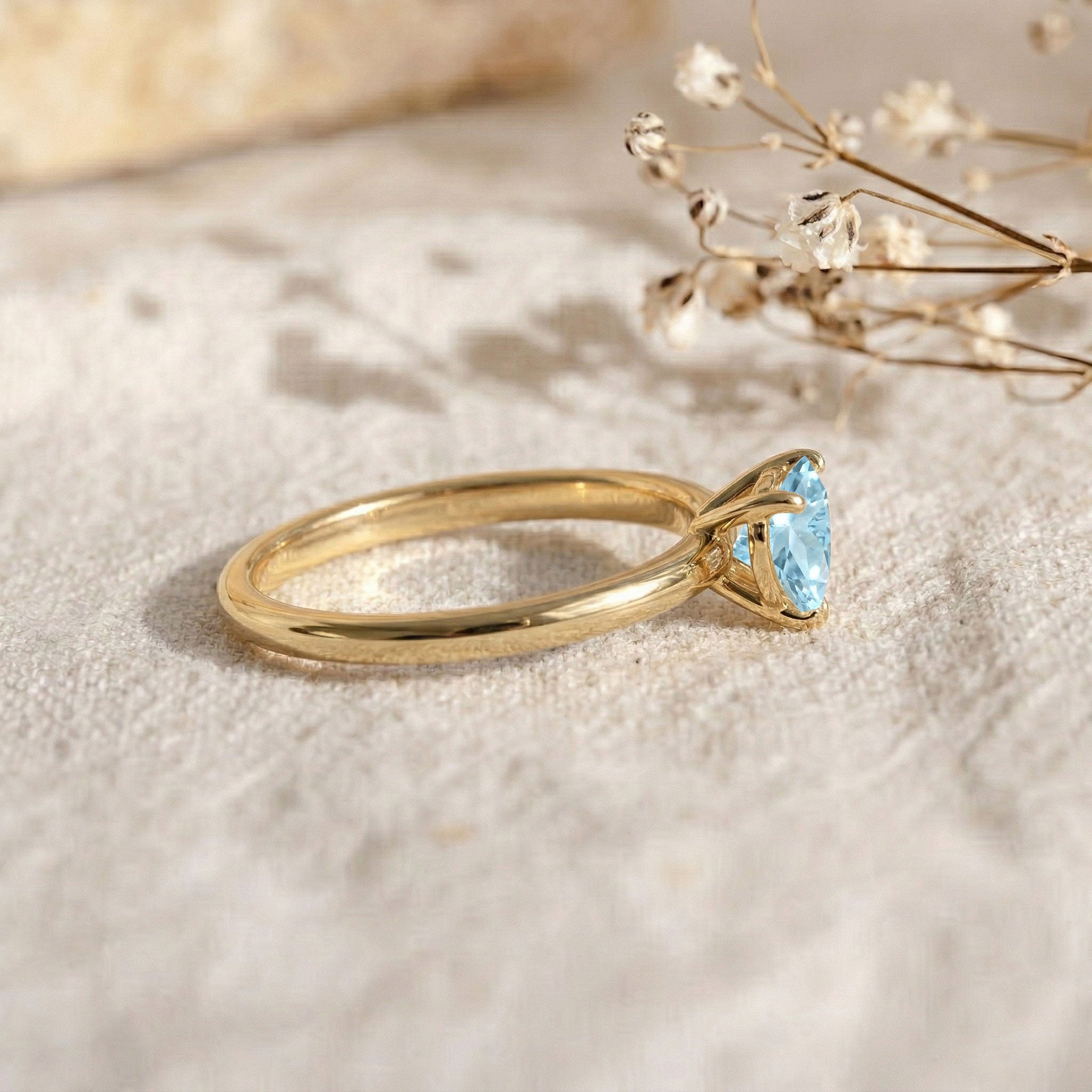 Blue heart gemstone solitaire, aquamarine engagement style ring, women's jewelry gift, dainty stacking ring, classic minimalist design, March birthstone present, artisan jewelry, polished metal ring, elegant gemstone accessory, romantic ring, everyday fashion jewelry, bridal look, handcrafted elegance, luxury style, timeless piece
