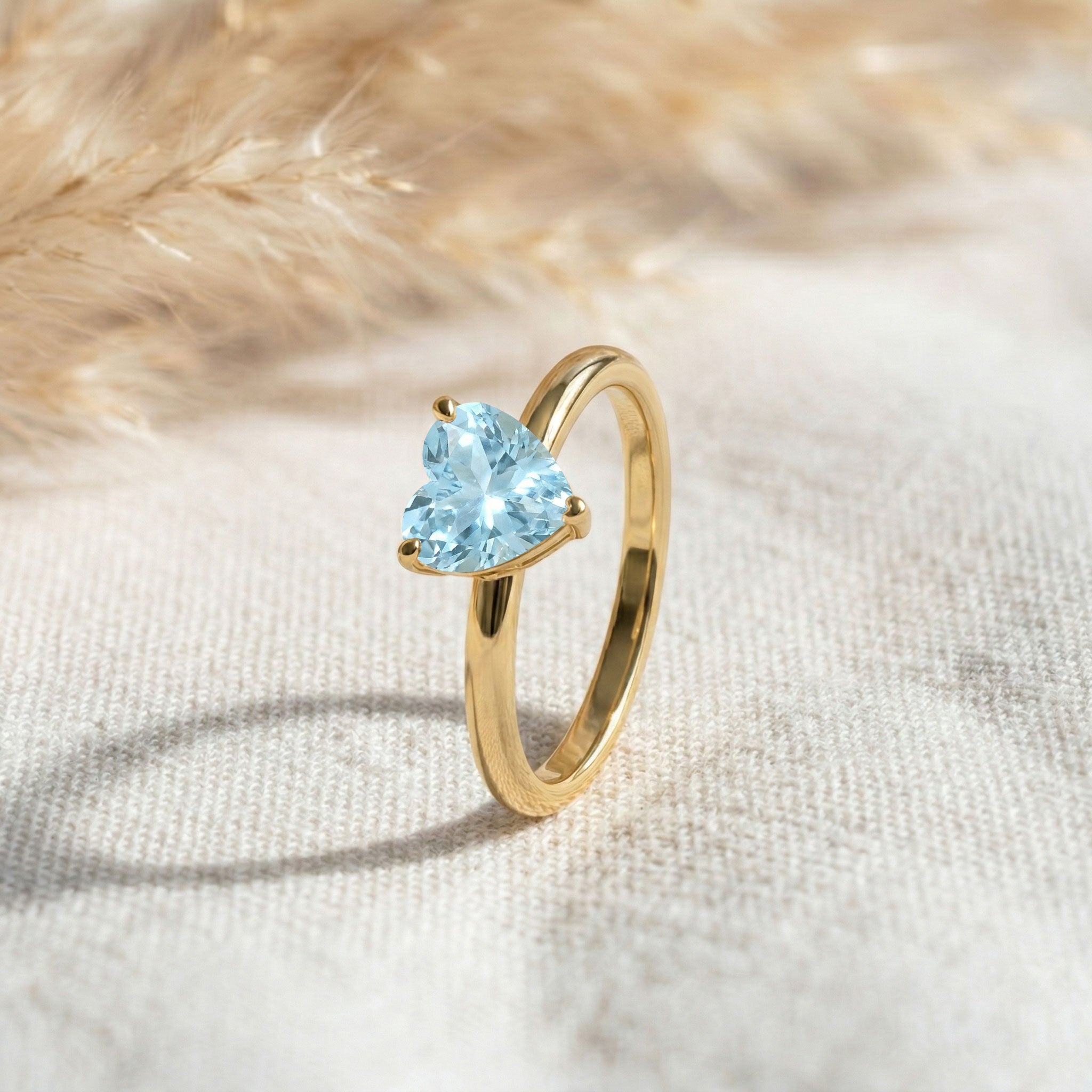 Heart shaped blue gemstone ring, aquamarine jewelry gift, solitaire promise jewelry, fine women's ring, March birthstone accessory, elegant everyday jewelry, minimalist engagement style, handcrafted craftsmanship, polished finish, feminine jewelry collection, birthday surprise, anniversary keepsake, luxury gift idea, delicate ring, fashion jewelry