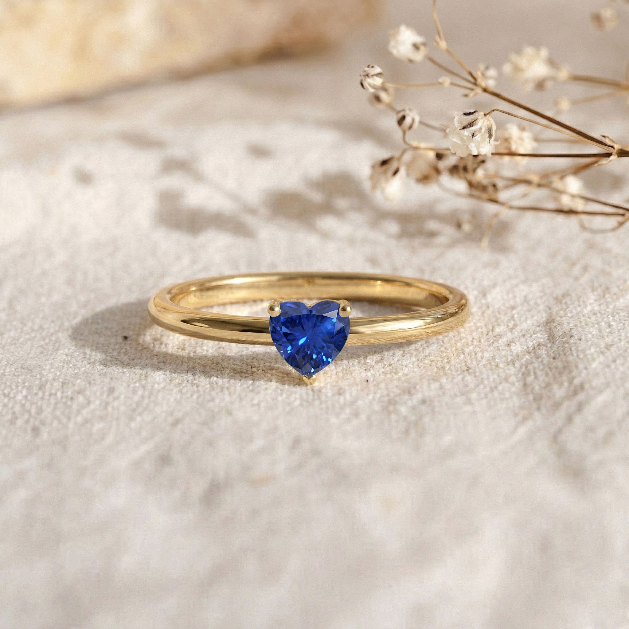blue heart gemstone ring, sapphire promise ring, handmade solitaire jewellery, sterling silver jewellery, gold filled ring option, anniversary jewellery, romantic gift idea, heart shaped gemstone, minimalist ring, elegant sapphire accessory, women's jewellery collection, september birthday gift, polished finish, luxury ring, artisan made