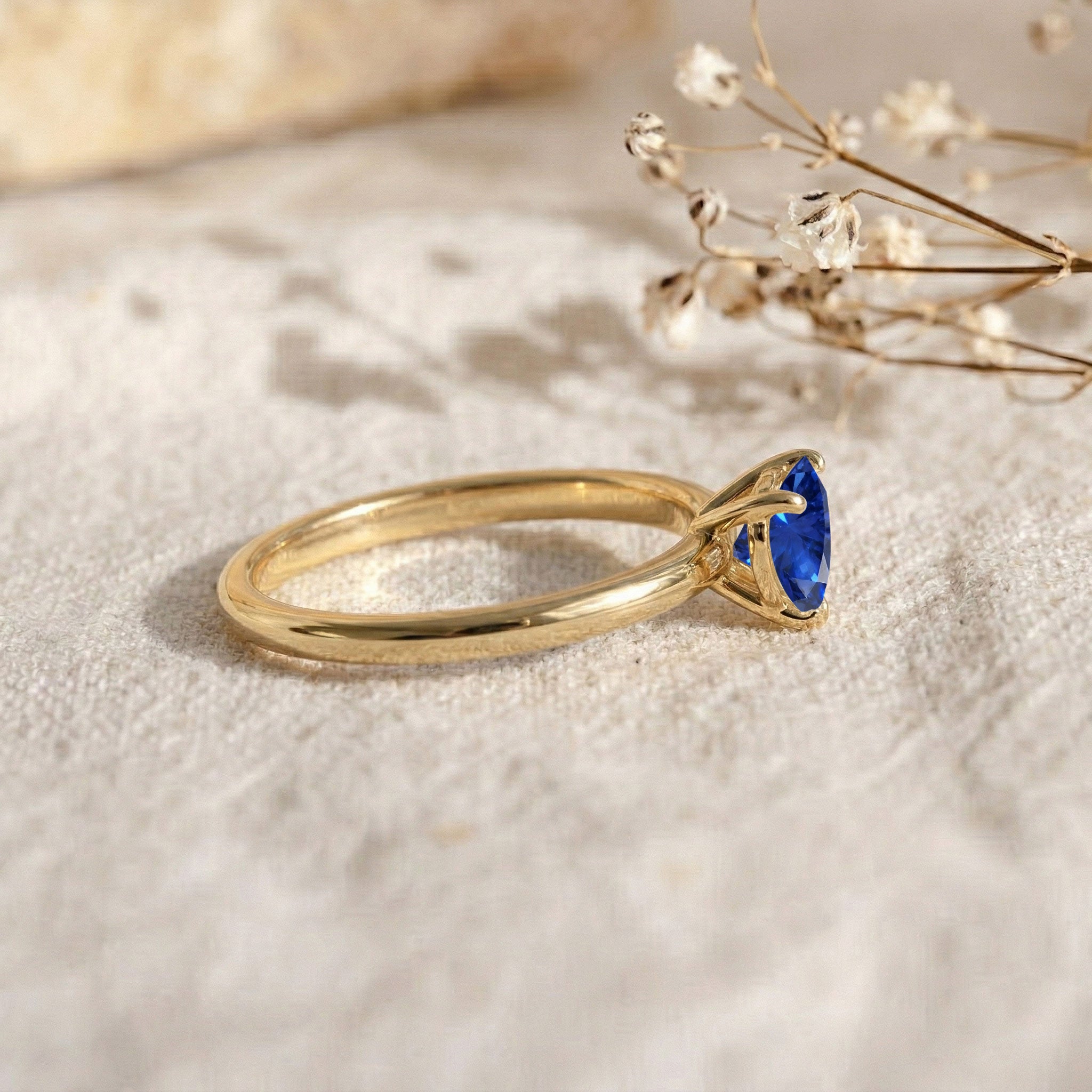 blue sapphire birthstone ring, heart cut gemstone jewellery, handcrafted artisan jewellery, sterling silver promise ring, yellow gold filled solitaire, elegant women's ring, romantic engagement jewellery, polished sapphire brilliance, september birthday gift, minimalist jewellery style, fine handcrafted accessory, anniversary jewellery, luxury ring, designer jewellery, timeless beauty