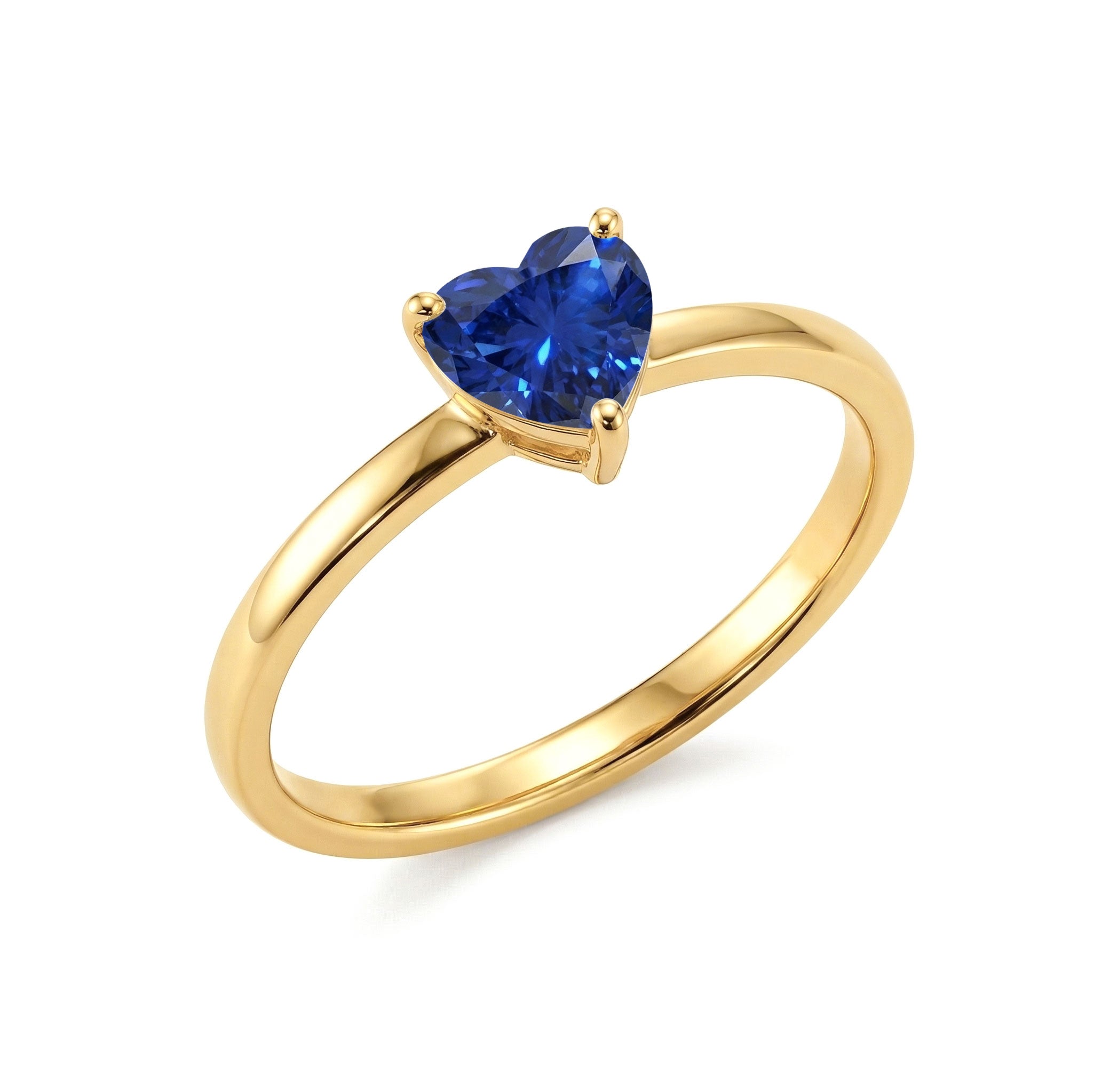 blue heart solitaire ring, sapphire jewellery for women, handcrafted fashion accessory, sterling silver ring, yellow gold filled jewellery, elegant gemstone design, promise jewellery, engagement inspired ring, september gemstone gift, artisan handcrafted ring, polished sapphire, luxury jewellery, timeless heart style, fine accessory, anniversary ring