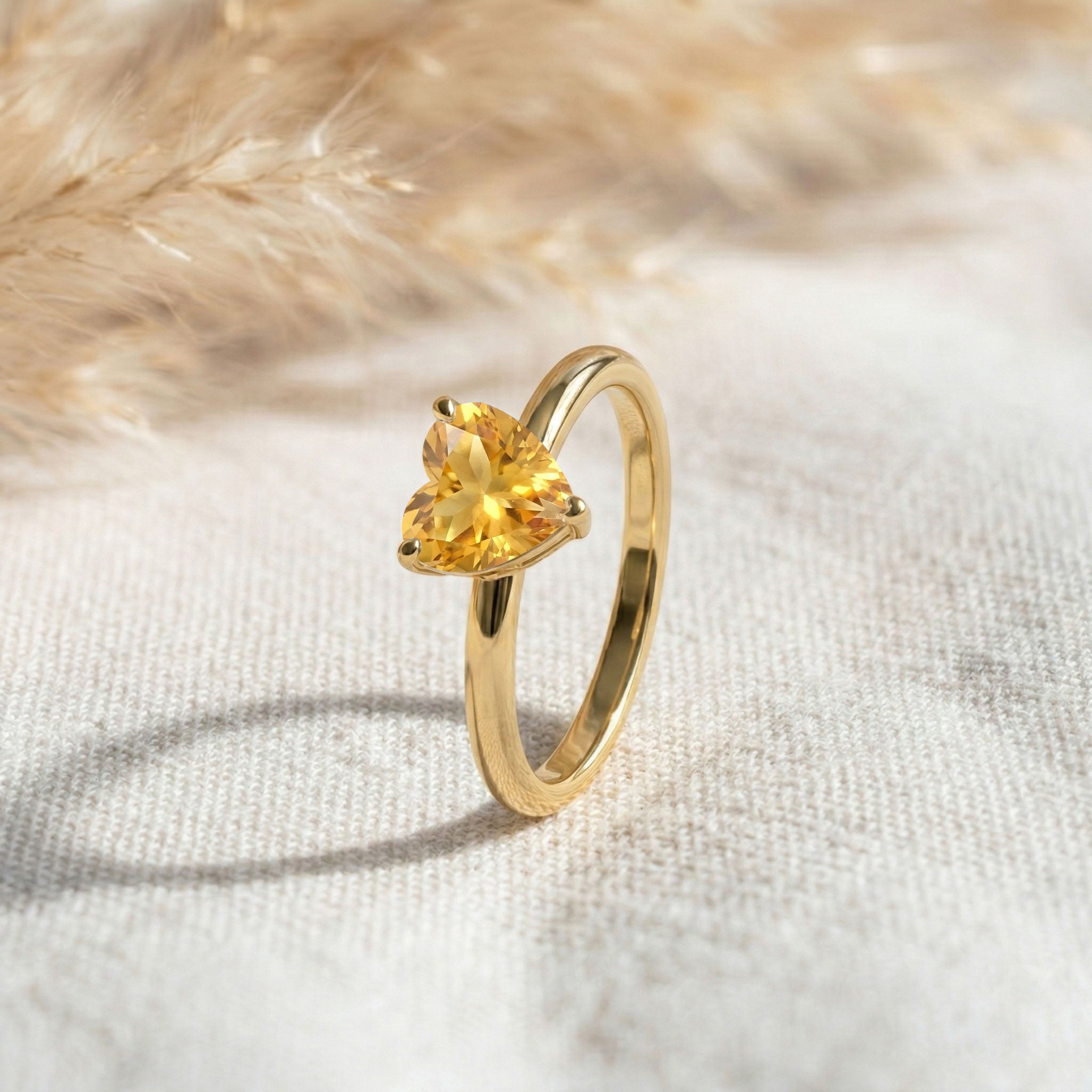 golden citrine gemstone ring, heart shaped fine jewelry, genuine gemstone gift, women's anniversary ring, elegant solitaire jewelry, minimalist style, handcrafted accessory, timeless ring, luxury gemstone jewelry, polished craftsmanship, modern fashion jewelry, delicate design, classic elegance, everyday accessory, birthstone jewelry