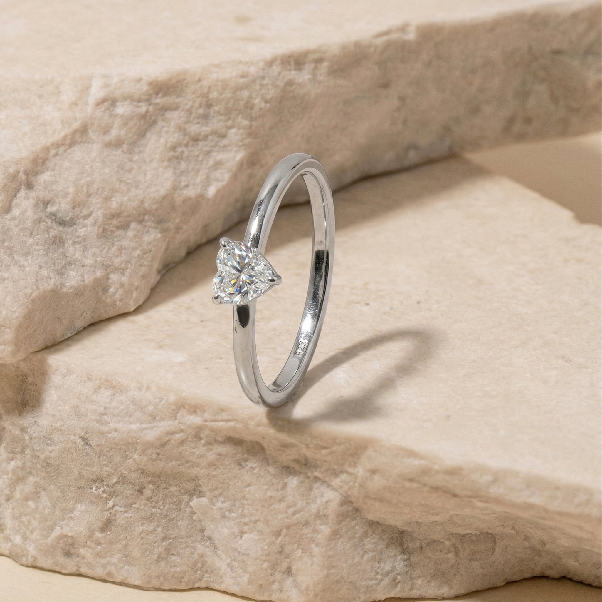 moissanite engagement style ring, classic heart gemstone, handcrafted elegant jewelry, women's luxury ring, polished jewelry design, sparkling solitaire gemstone, timeless accessory, sophisticated fashion jewelry, artisan craftsmanship, meaningful jewelry gift, fine ring style, premium elegance, everyday luxury, romantic ring, heart jewelry
