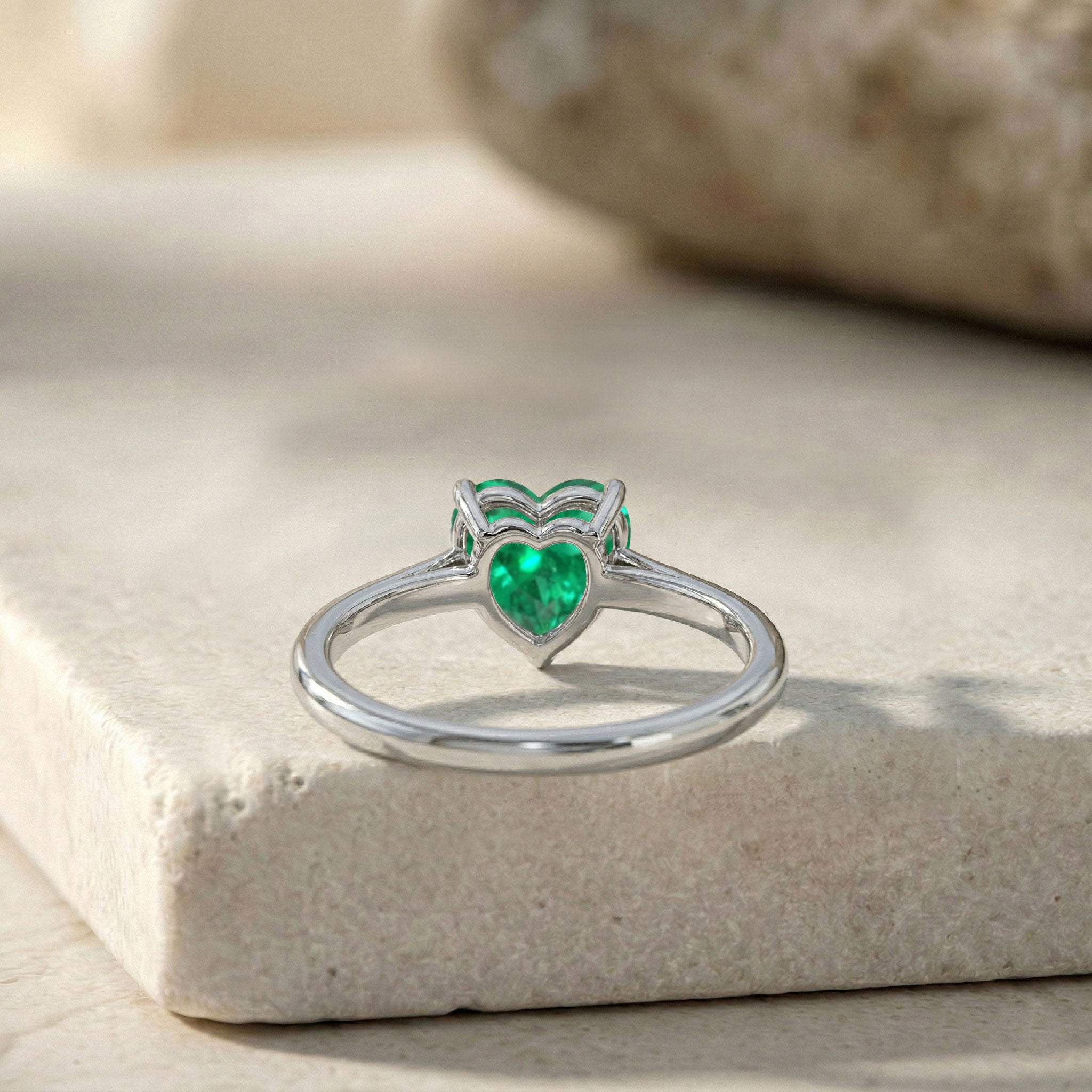 heart gemstone fashion ring, emerald jewelry collection, solitaire gemstone accessory, polished heart jewelry, elegant green gemstone, timeless women's jewelry, handcrafted fine ring, luxury emerald style, anniversary jewelry gift, birthstone accessory, classic elegance, refined design, fashionable ring, delicate jewelry, modern solitaire