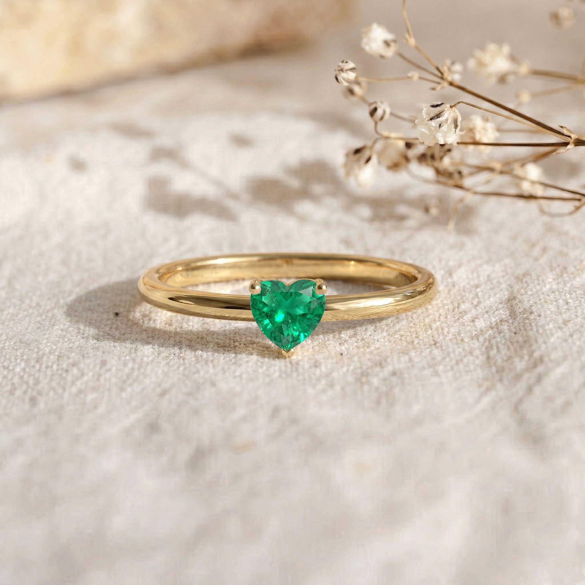 heart cut green stone, emerald engagement ring, women's emerald jewelry, classic solitaire style, luxury gemstone ring, refined jewelry, elegant heart design, emerald gift for her, stackable ring, fine craftsmanship, polished finish, modern jewelry, timeless elegance, minimalist fashion, everyday accessory