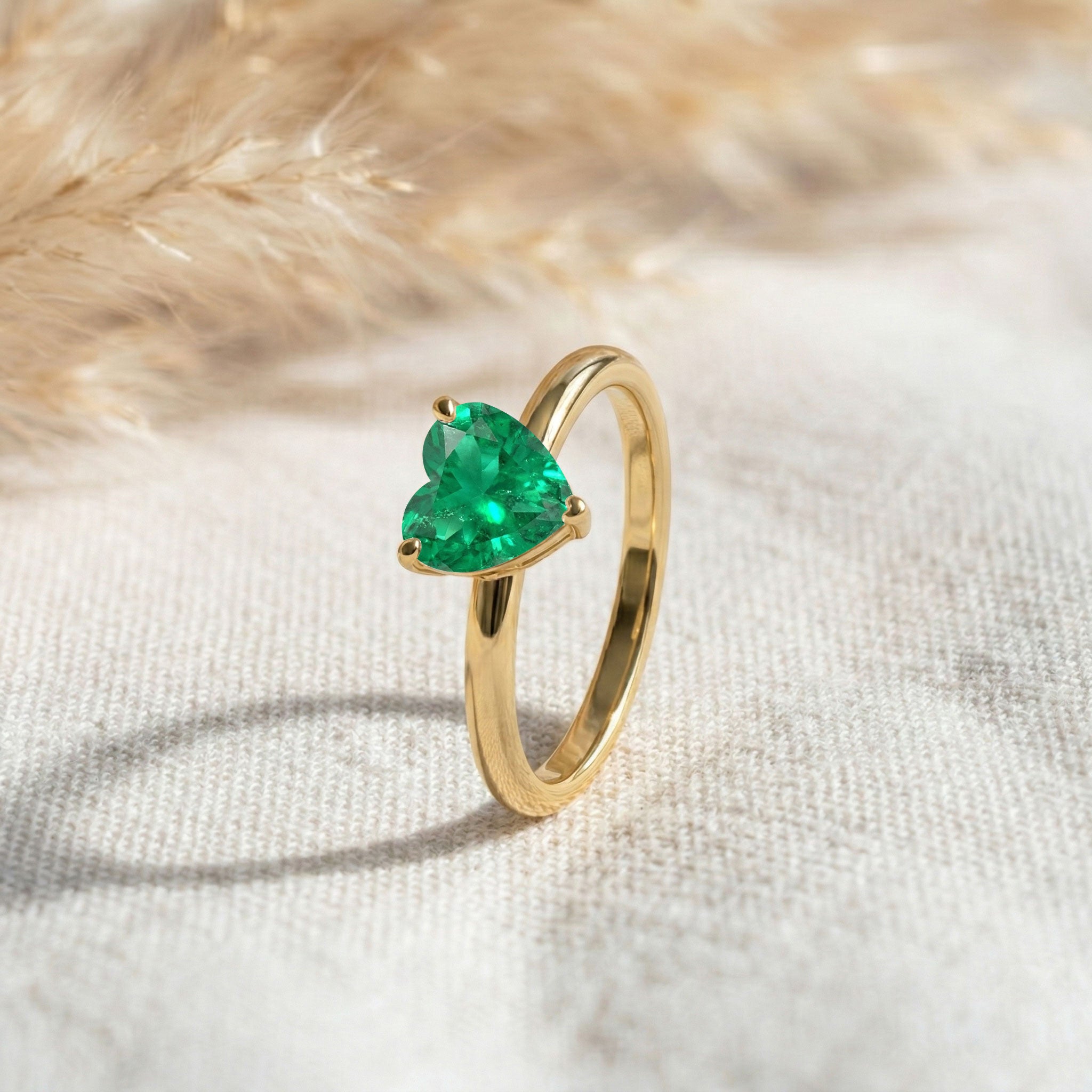 heart shaped emerald jewelry, emerald gemstone accessory, solitaire fashion ring, elegant promise jewelry, women's emerald gift, green gemstone accessory, sophisticated ring, dainty solitaire jewelry, fine emerald design, timeless gift idea, minimalist jewelry, polished craftsmanship, romantic jewelry, elegant everyday ring, luxury style