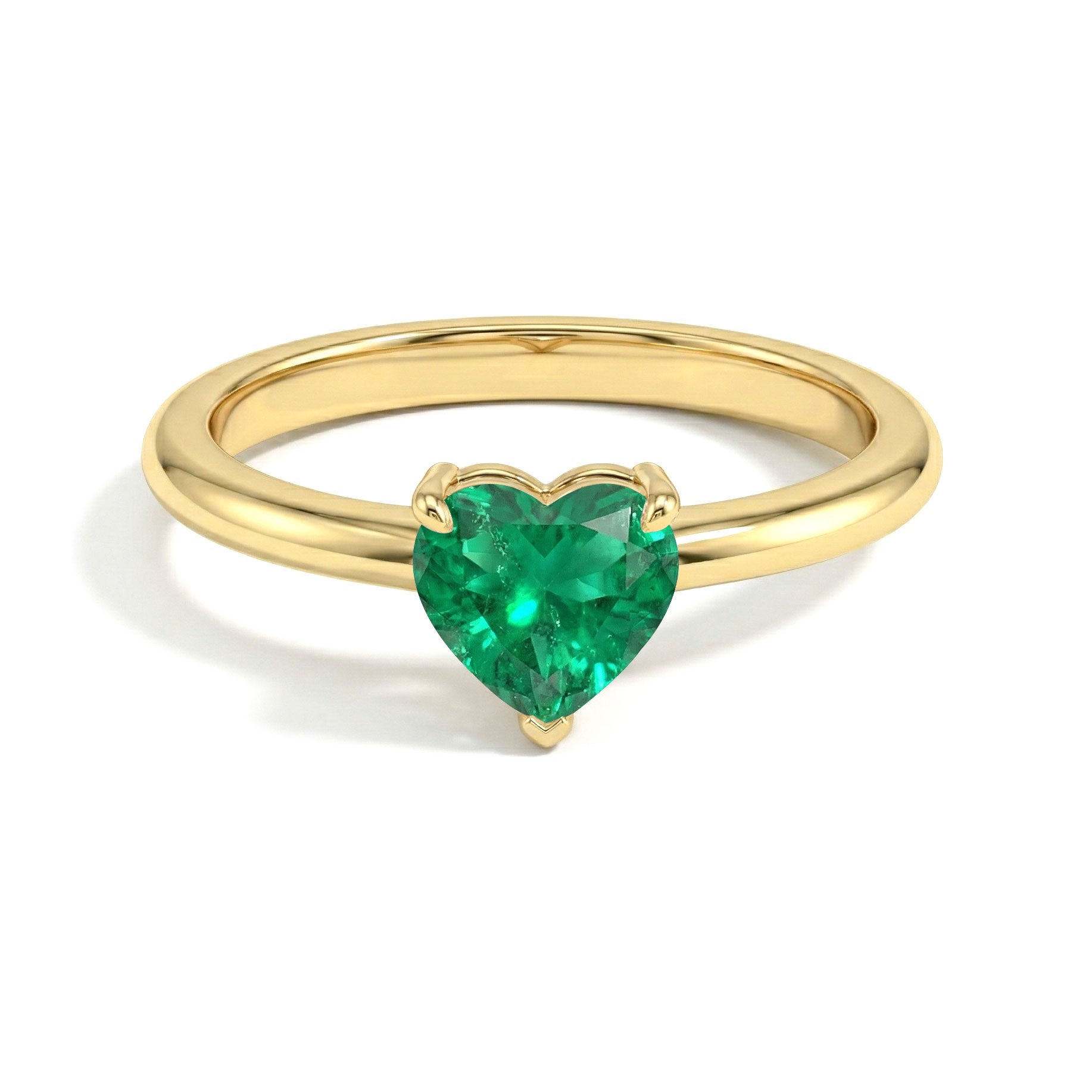 heart cut solitaire jewelry, emerald gemstone elegance, green birthstone ring, classic emerald accessory, luxury jewelry gift, polished craftsmanship, refined women's ring, elegant gemstone style, promise jewelry idea, timeless fine jewelry, handcrafted elegance, modern ring design, anniversary accessory, sophisticated fashion, heart gemstone jewelry