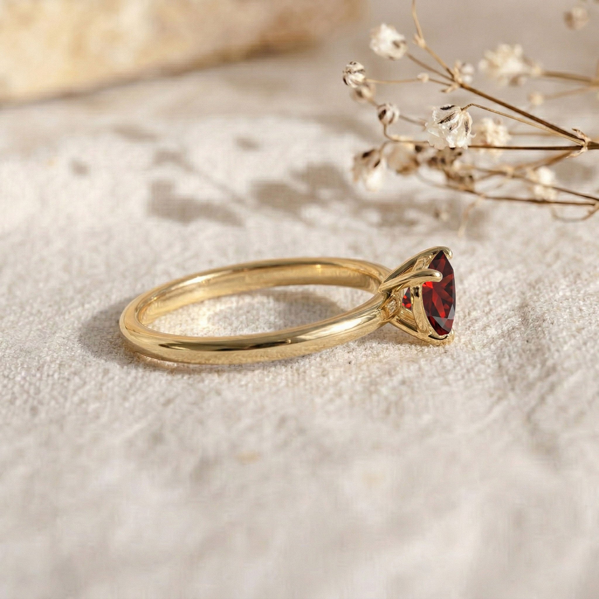 heart birthstone jewelry, garnet gemstone fashion ring, handcrafted artisan accessory, minimalist polished band, women's promise jewelry, timeless solitaire design, refined gemstone craftsmanship, anniversary jewelry gift, natural red gemstone, stackable ring collection, luxury handcrafted piece, elegant fine jewelry, sophisticated heart ring, comfort fit design