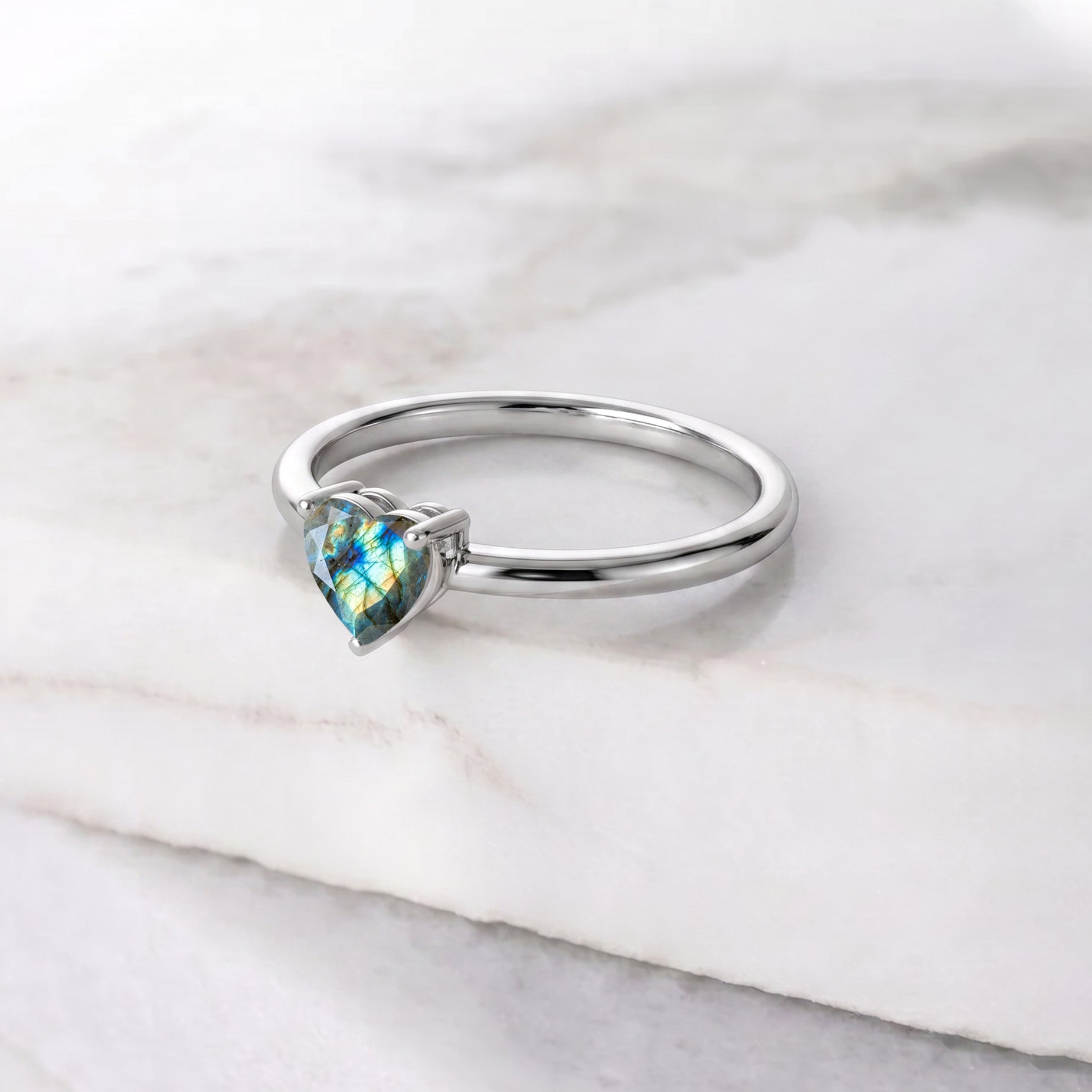 blue flash labradorite jewelry, heart shaped gemstone ring, solitaire handcrafted design, elegant fashion accessory, premium gemstone craftsmanship, natural stone jewelry, romantic heart ring, women's everyday jewelry, meaningful gemstone gift, artisan jewelry creation, polished elegance, timeless gemstone style, classic solitaire ring, refined details, luxurious simplicity