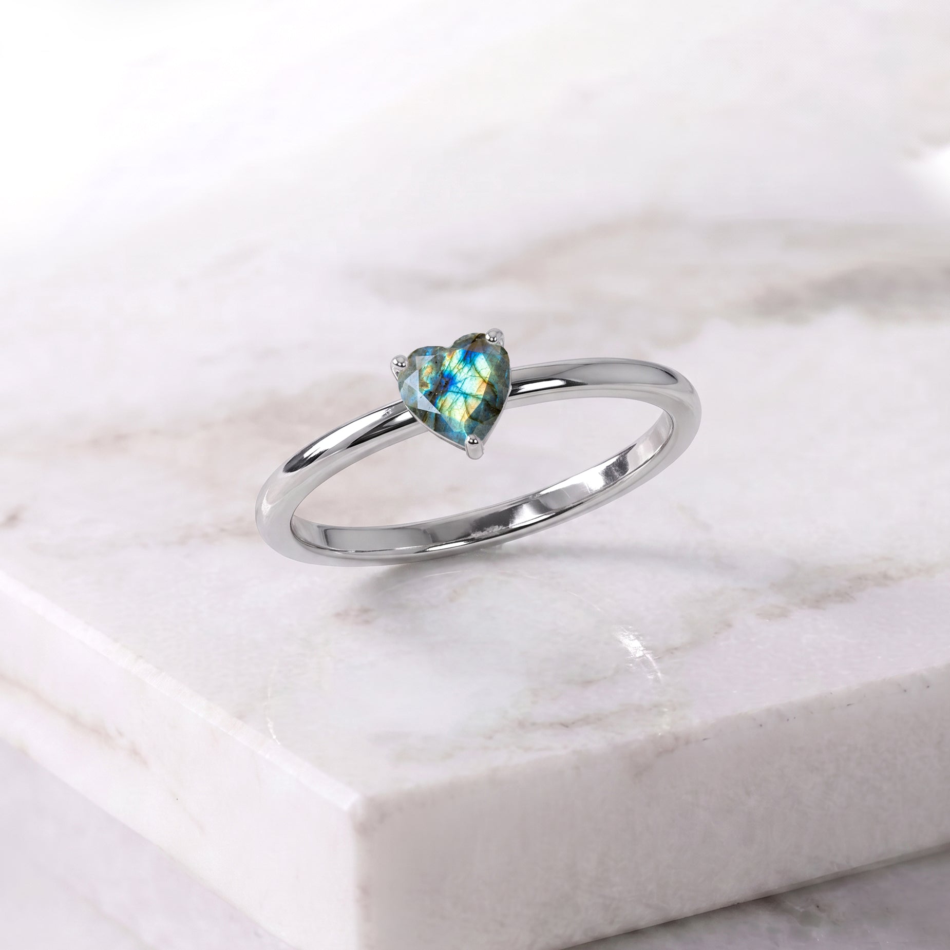natural labradorite ring details, heart gemstone centerpiece, solitaire elegance, handcrafted artisan jewelry, classic women's ring, gemstone sparkle, refined jewelry craftsmanship, minimalist elegant accessory, polished gemstone design, meaningful jewelry collection, anniversary keepsake, fashion jewelry gift, sophisticated style, timeless beauty, premium gemstone