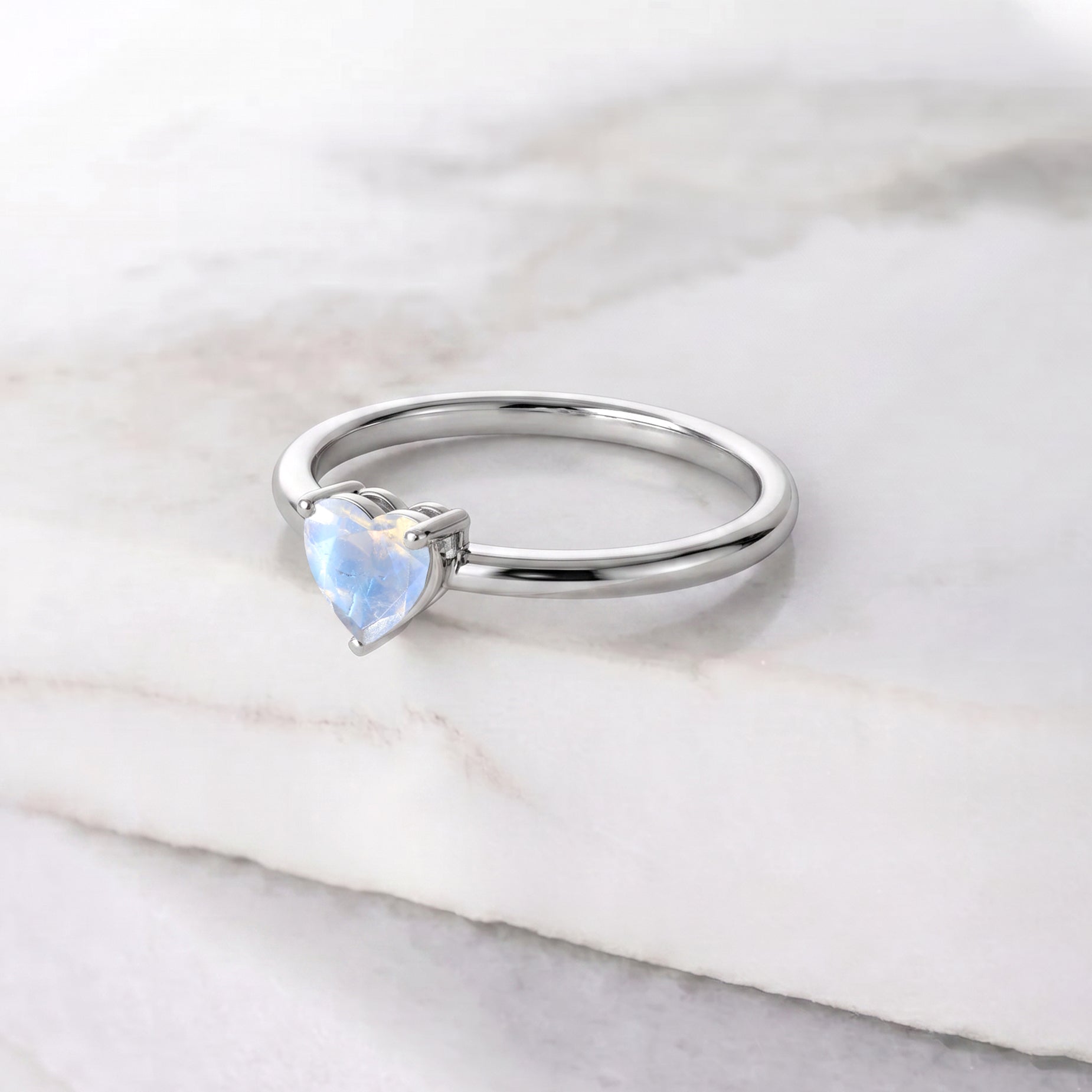 moonstone solitaire ring, heart gemstone centerpiece, handcrafted jewelry art, elegant women's ring, natural gemstone fashion, fine jewelry collection, meaningful gift idea, promise jewelry, anniversary surprise, birthday accessory, timeless gemstone design, artisan craftsmanship, romantic jewelry style, polished elegance, gemstone ring