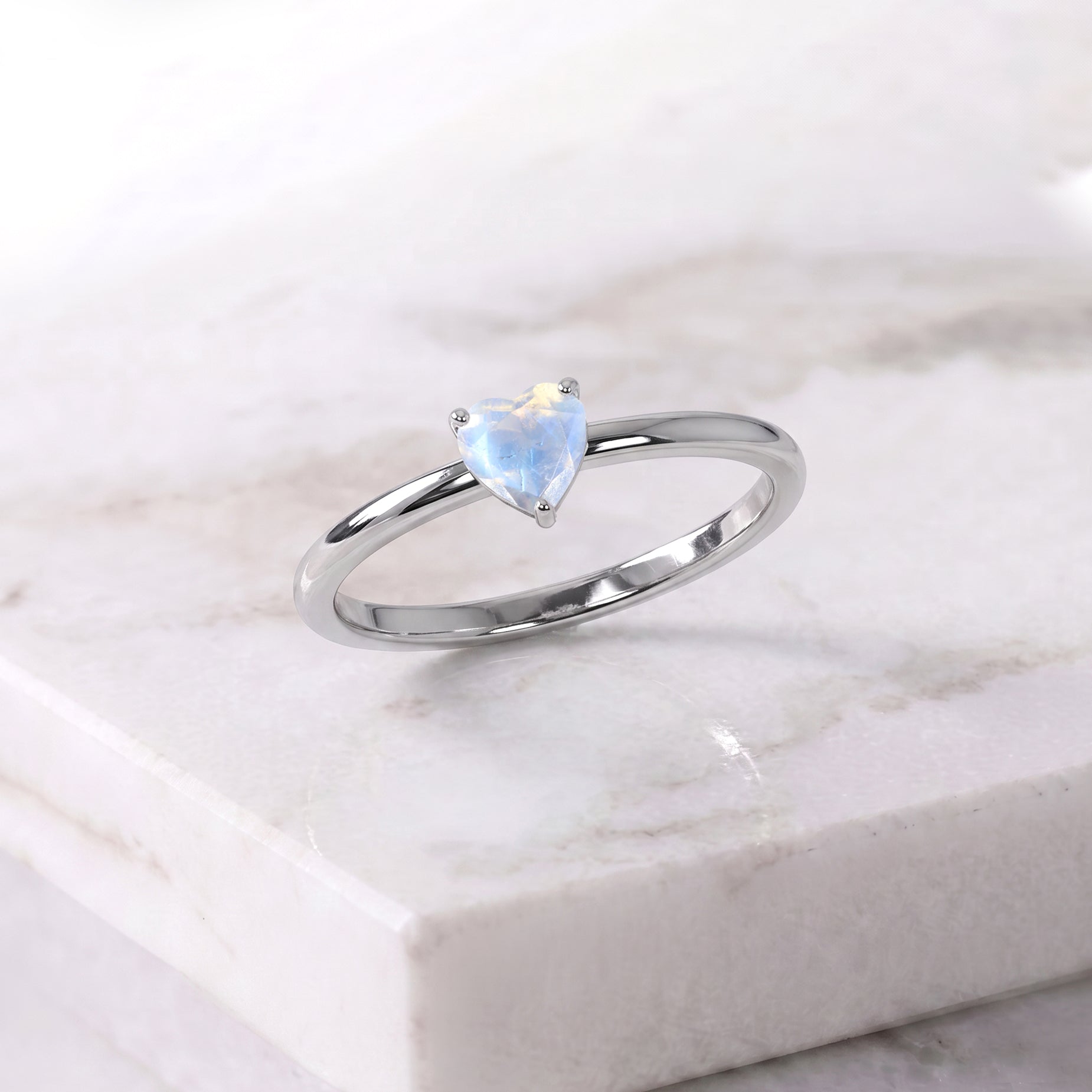 moonstone heart solitaire jewelry, handcrafted ring design, natural gemstone accessory, women's elegant jewelry, gemstone promise ring, classic heart jewelry, anniversary gift idea, refined craftsmanship, everyday jewelry style, timeless fashion accessory, premium gemstone, artisan ring, romantic jewelry, polished gemstone, fine jewelry