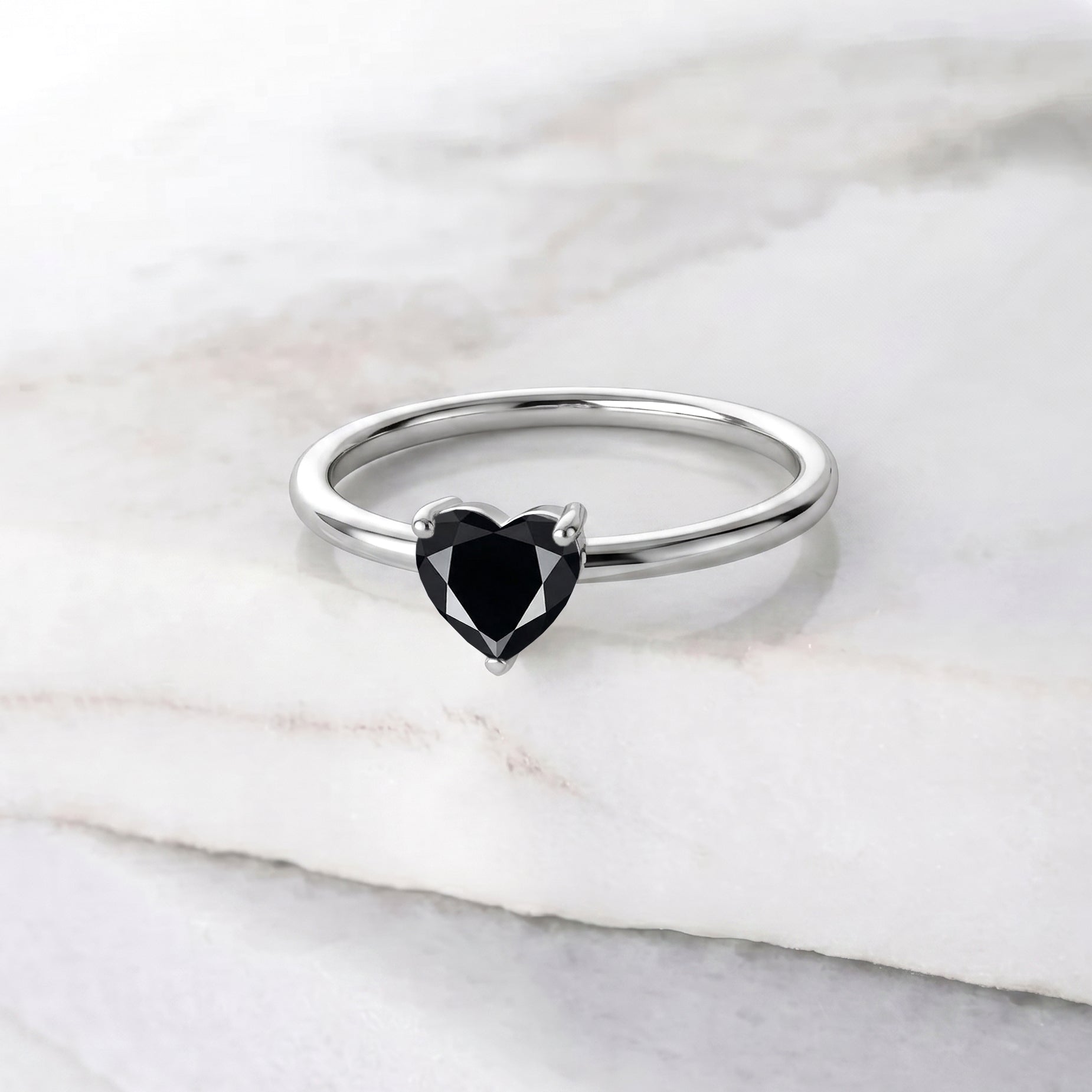 natural black onyx solitaire, heart cut gemstone jewelry, elegant women's ring, handcrafted gemstone design, black gemstone fashion accessory, minimalist heart ring, fine jewelry craftsmanship, classic engagement style, romantic gift jewelry, timeless accessory, birthday gift idea, artisan jewelry collection, polished gemstone ring, promise jewelry, luxury ring