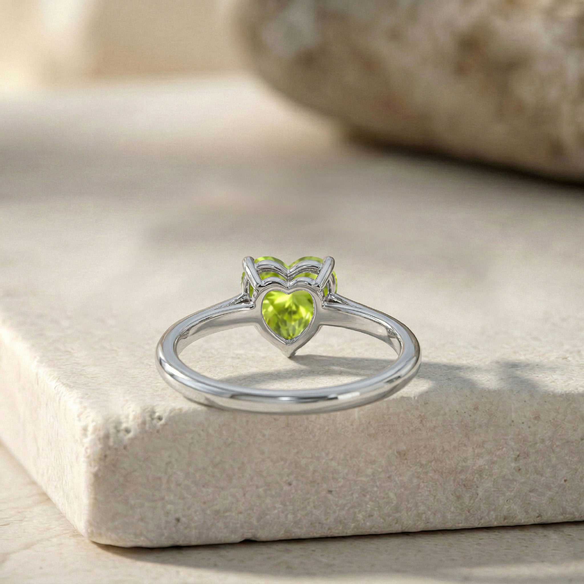 green peridot heart jewelry, natural gemstone ring, elegant solitaire accessory, timeless birthstone gift, polished minimalist band, feminine ring fashion, luxury jewelry piece, everyday heart ring, anniversary gemstone jewelry, refined handcrafted design, stylish women ring
