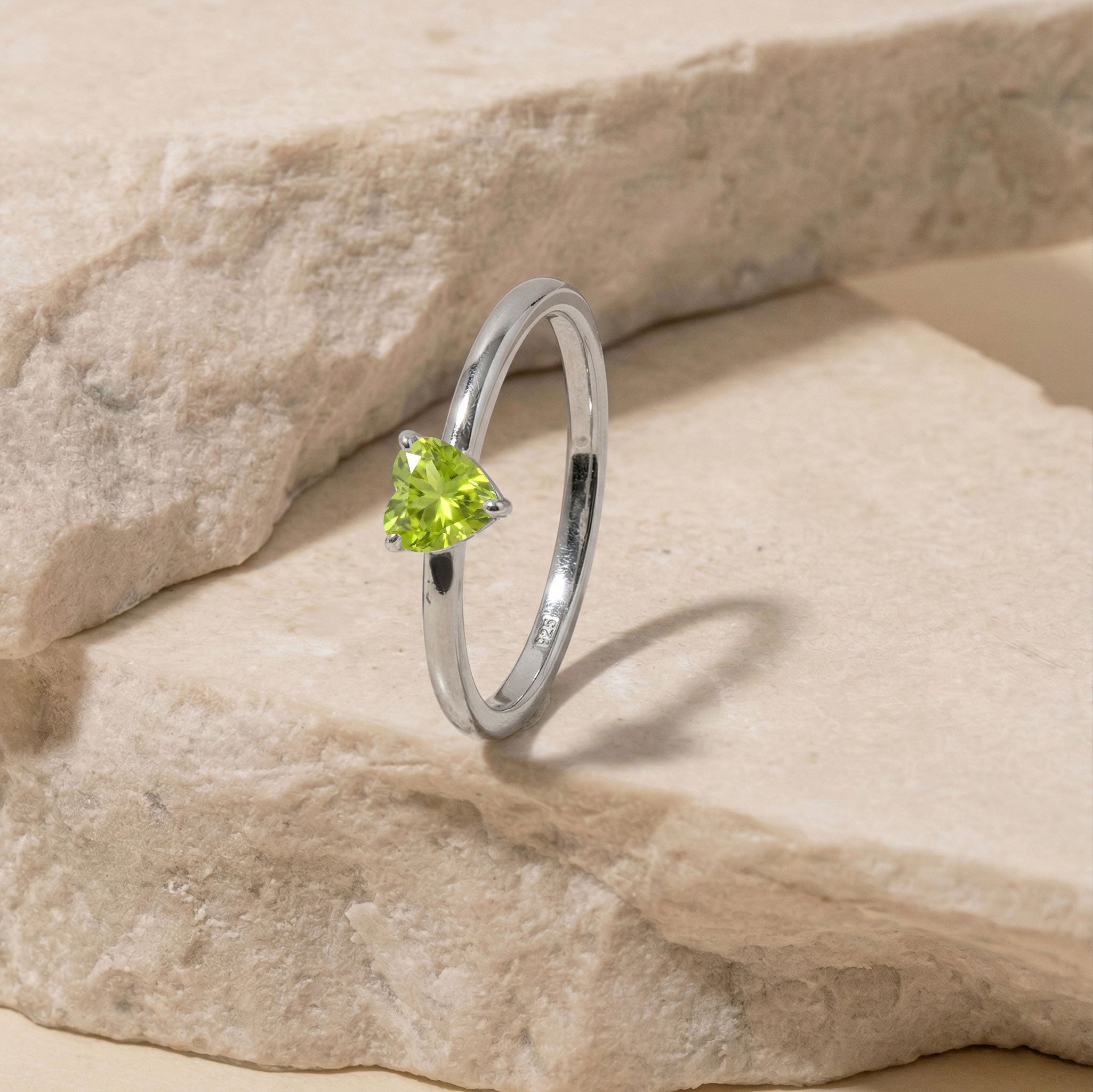 minimalist peridot solitaire ring, natural heart gemstone, green jewelry accessory, polished band design, elegant birthstone jewelry, timeless promise jewelry, feminine fashion ring, anniversary present idea, simple luxury jewelry, refined gemstone accessory, heart ring women