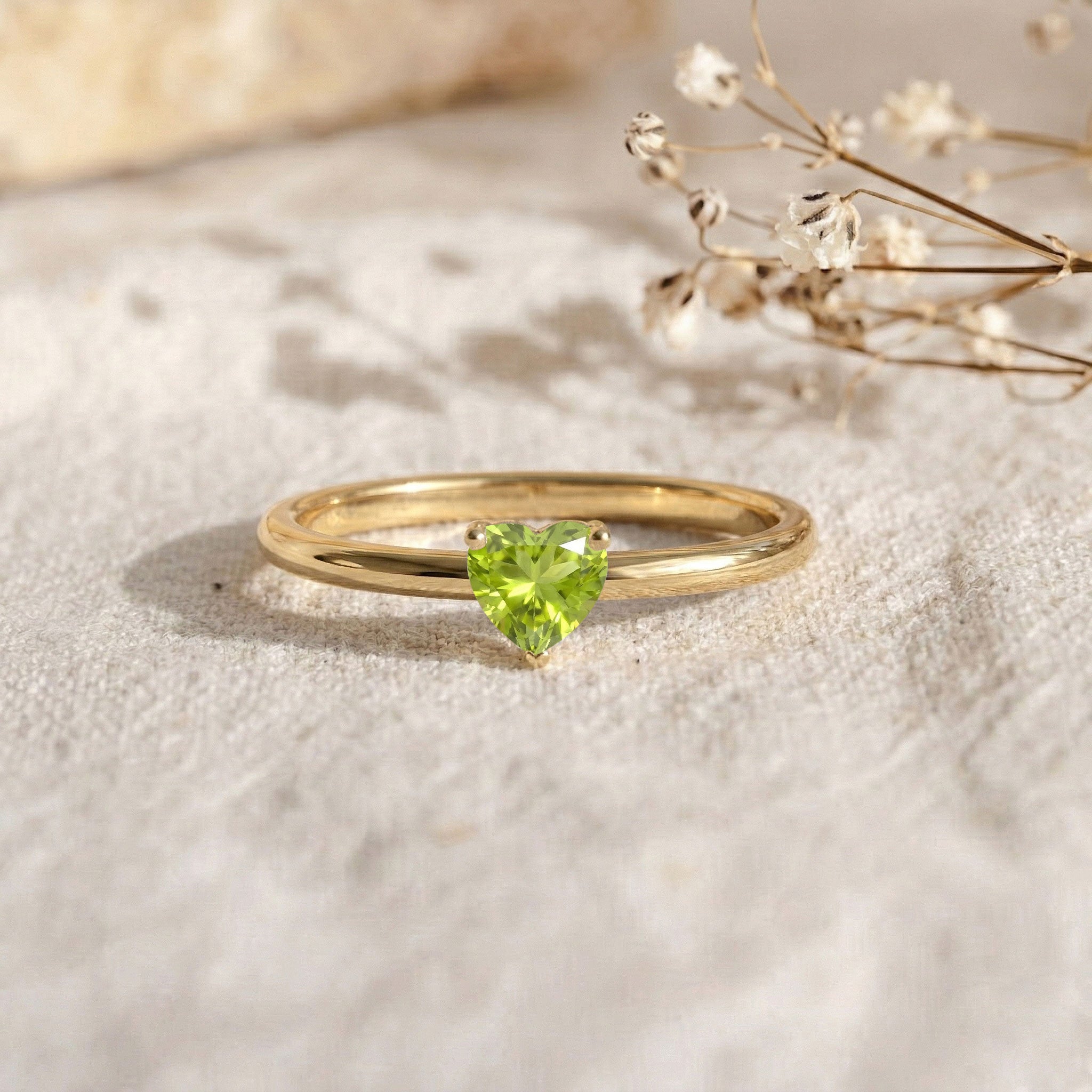 heart cut natural peridot gemstone, solitaire green ring, august birthstone jewelry, polished band ring, minimal jewelry design, elegant gemstone accessory, classic promise ring, heart stone jewelry, everyday fine jewelry, stylish women's ring, delicate ring style