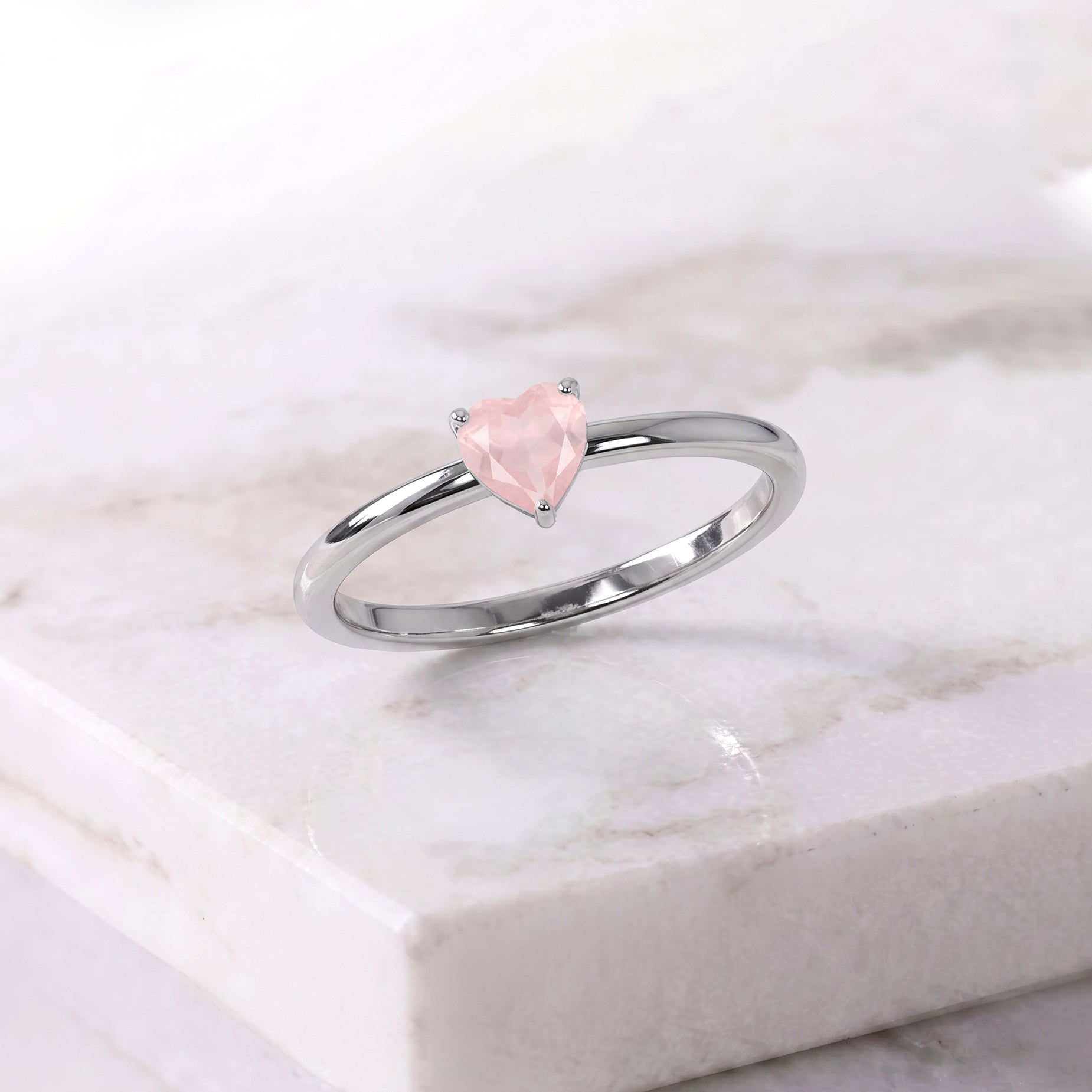 natural rose quartz jewelry, elegant heart gemstone, solitaire fine jewelry, artisan handcrafted accessory, romantic jewelry gift, women's gemstone fashion, promise ring jewelry, polished gemstone ring, classic jewelry style, anniversary gift, birthday jewelry, timeless gemstone accessory, fine jewelry craftsmanship, luxury minimalist jewelry, gemstone design