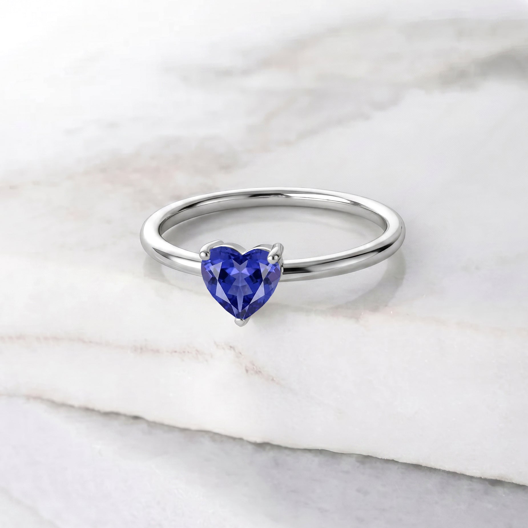 heart gemstone ring, lab tanzanite jewelry, handcrafted women's accessory, elegant fine jewelry, gemstone fashion ring, artisan craftsmanship, december birthstone ring, classic heart design, polished ring, anniversary keepsake, birthday present, timeless gemstone jewelry, romantic ring, sophisticated accessory, minimalist jewelry