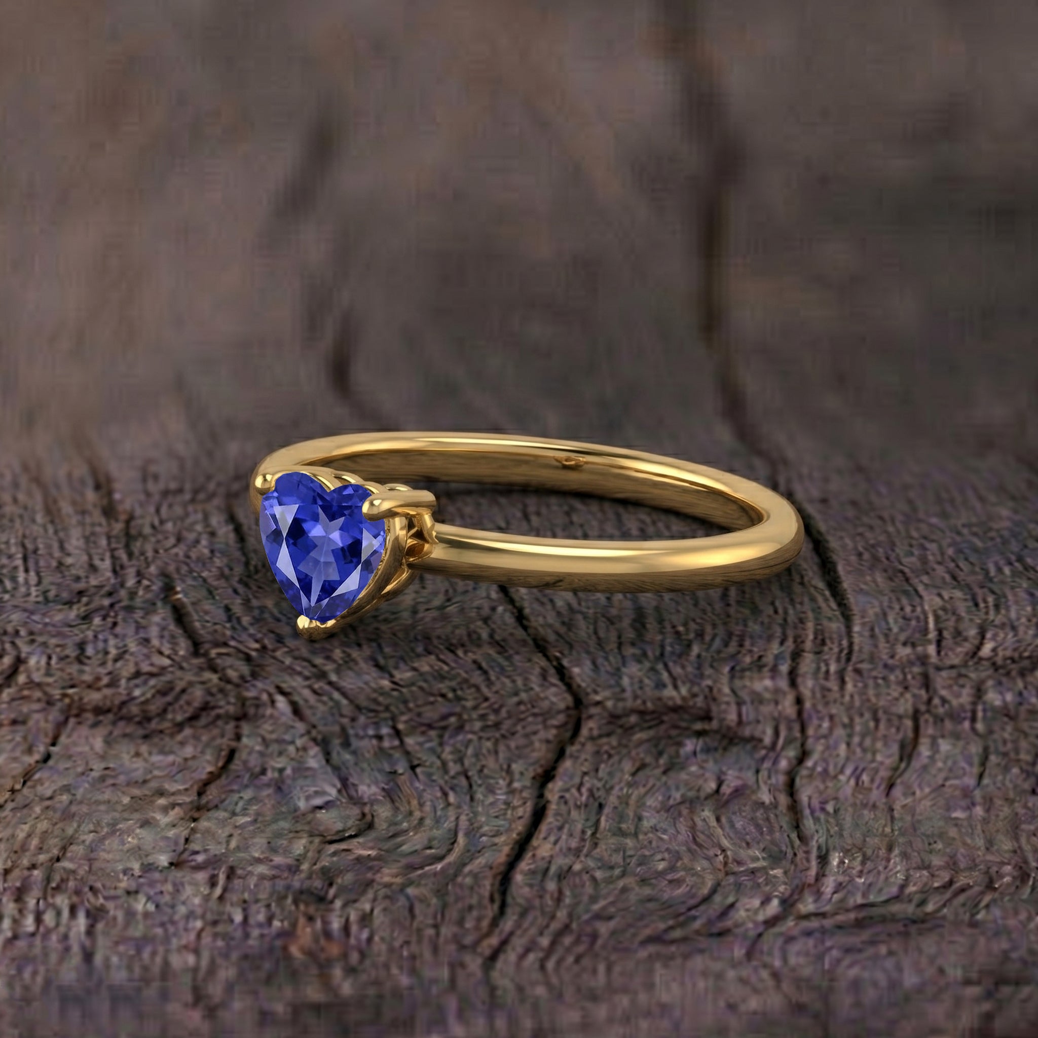 heart cut gemstone ring, tanzanite solitaire jewelry, handcrafted fine ring, elegant fashion accessory, gemstone promise ring, romantic jewelry gift, women's timeless jewelry, artisan gemstone design, polished elegance, december jewelry, sophisticated craftsmanship, birthday gift, anniversary jewelry, premium ring, minimalist style