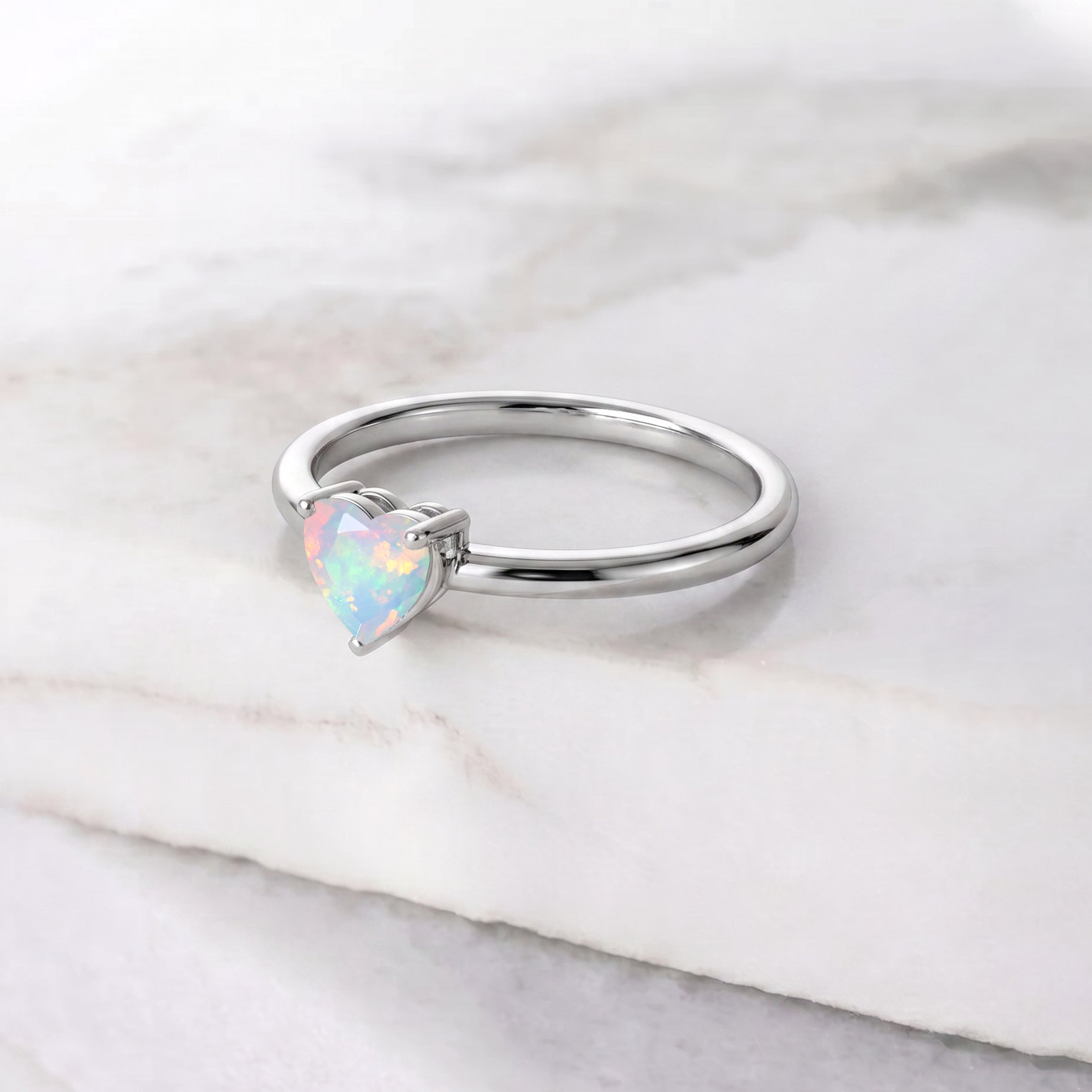 heart shaped white opal jewelry, solitaire gemstone ring, natural october gemstone, elegant promise jewelry, women's everyday accessory, handmade ring, minimalist style, polished craftsmanship, gemstone fashion jewelry, timeless gift, bridal inspiration, delicate jewelry, artisan gemstone design, sophisticated ring, romantic elegance